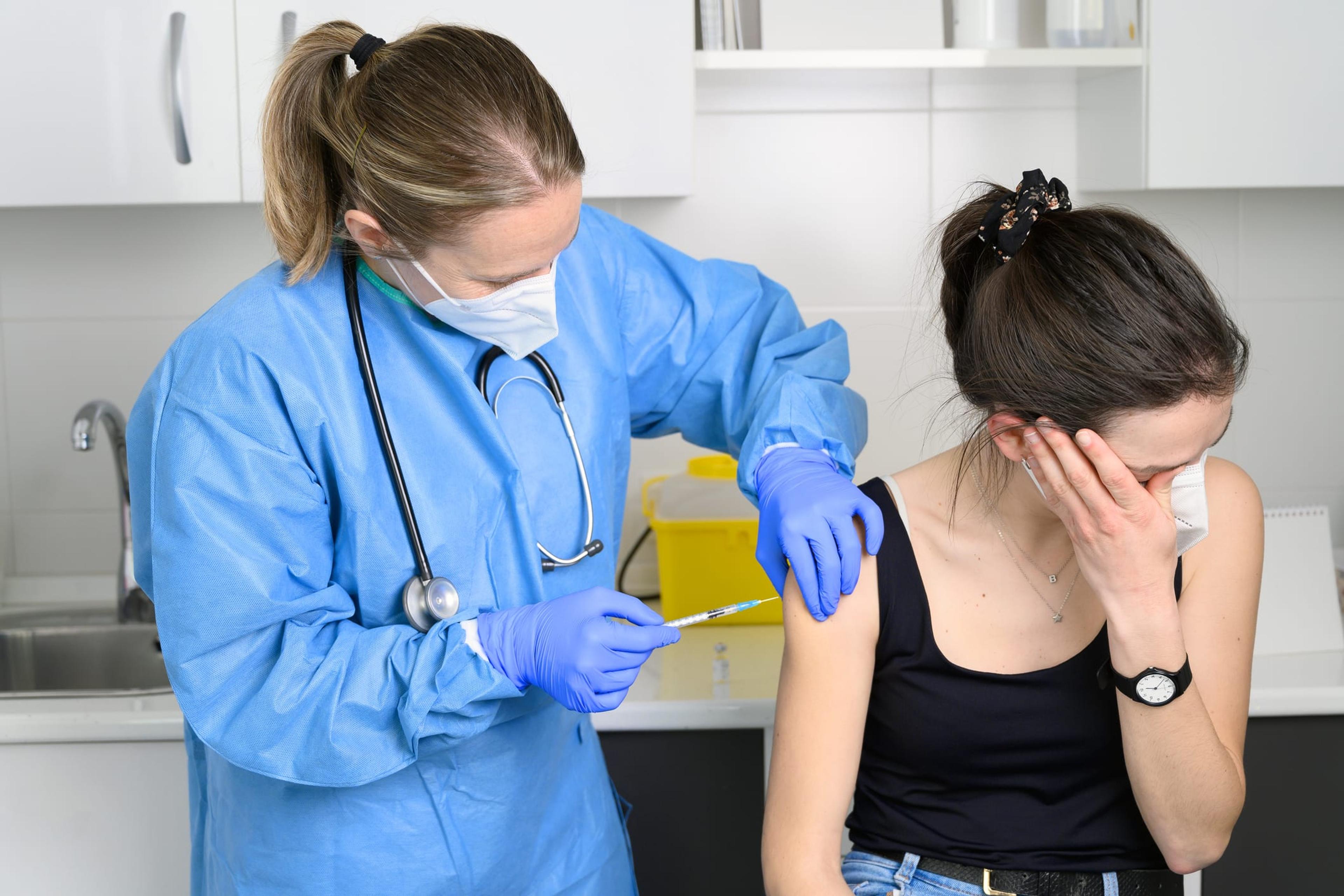 Worried woman receives a COVID vaccine