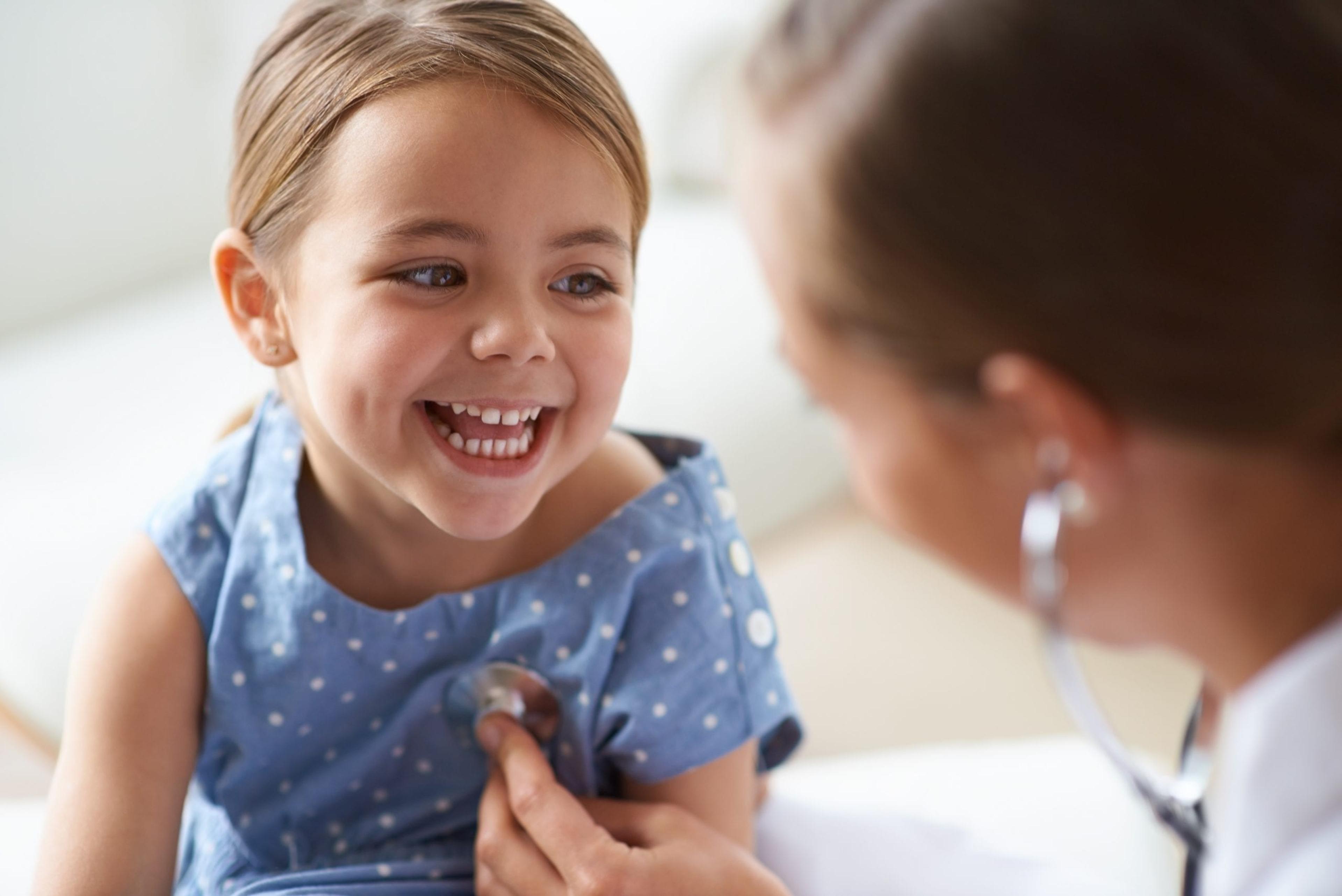 Little girl smiling at her doctor