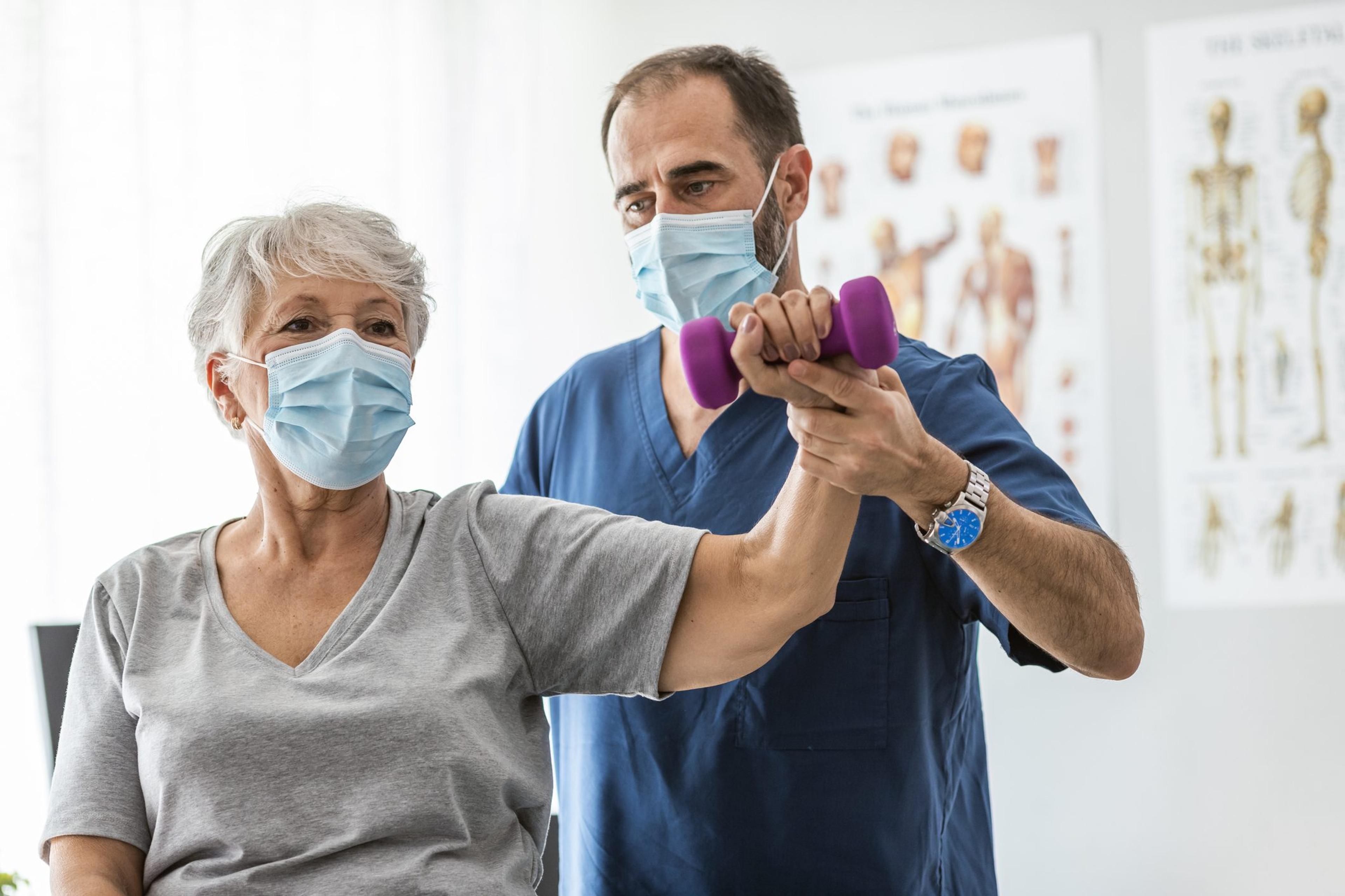 Physical Therapist Helping Senior Woman Improve Mobility and Prevent Osteoporosis