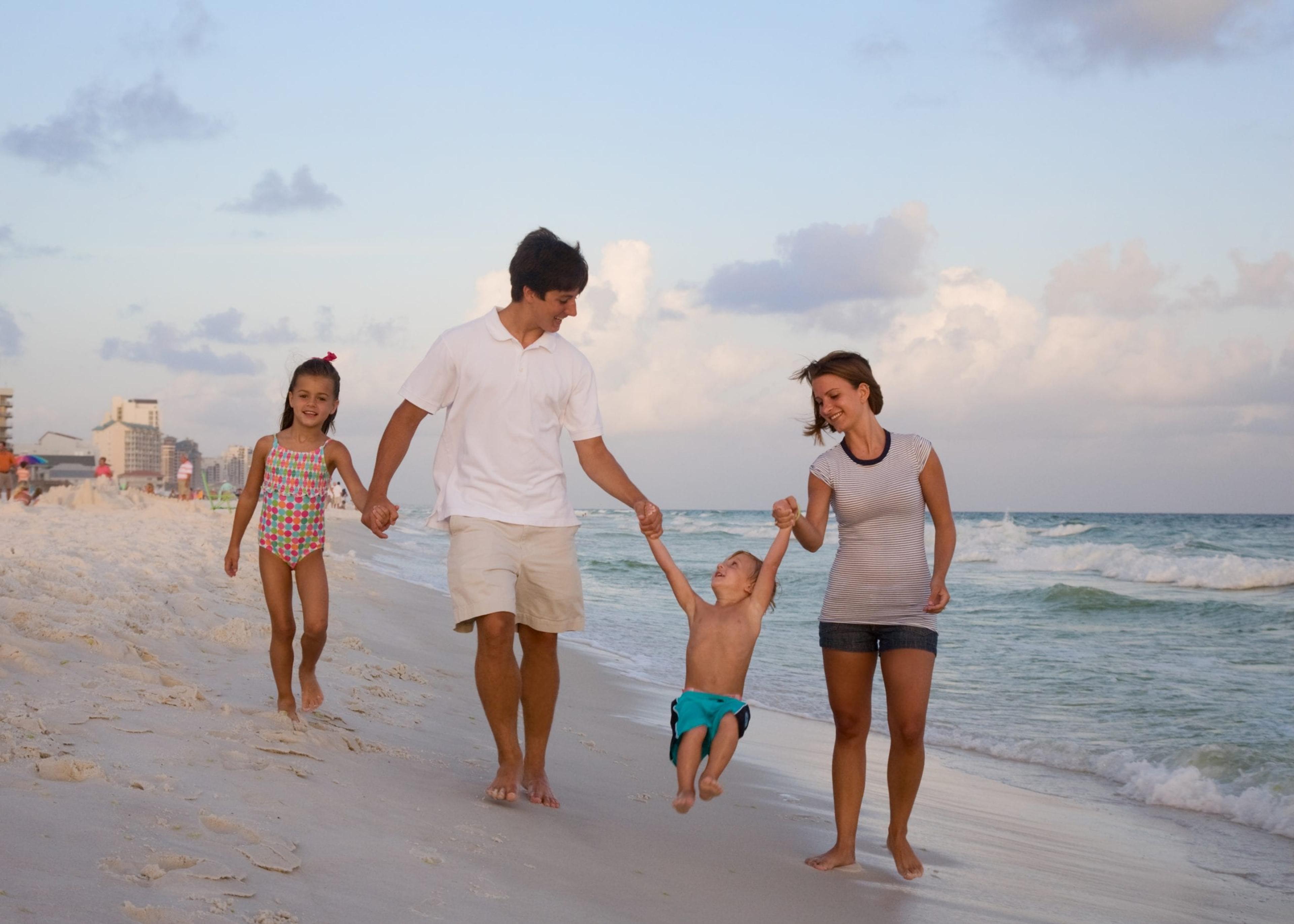 Young family playing on the beach