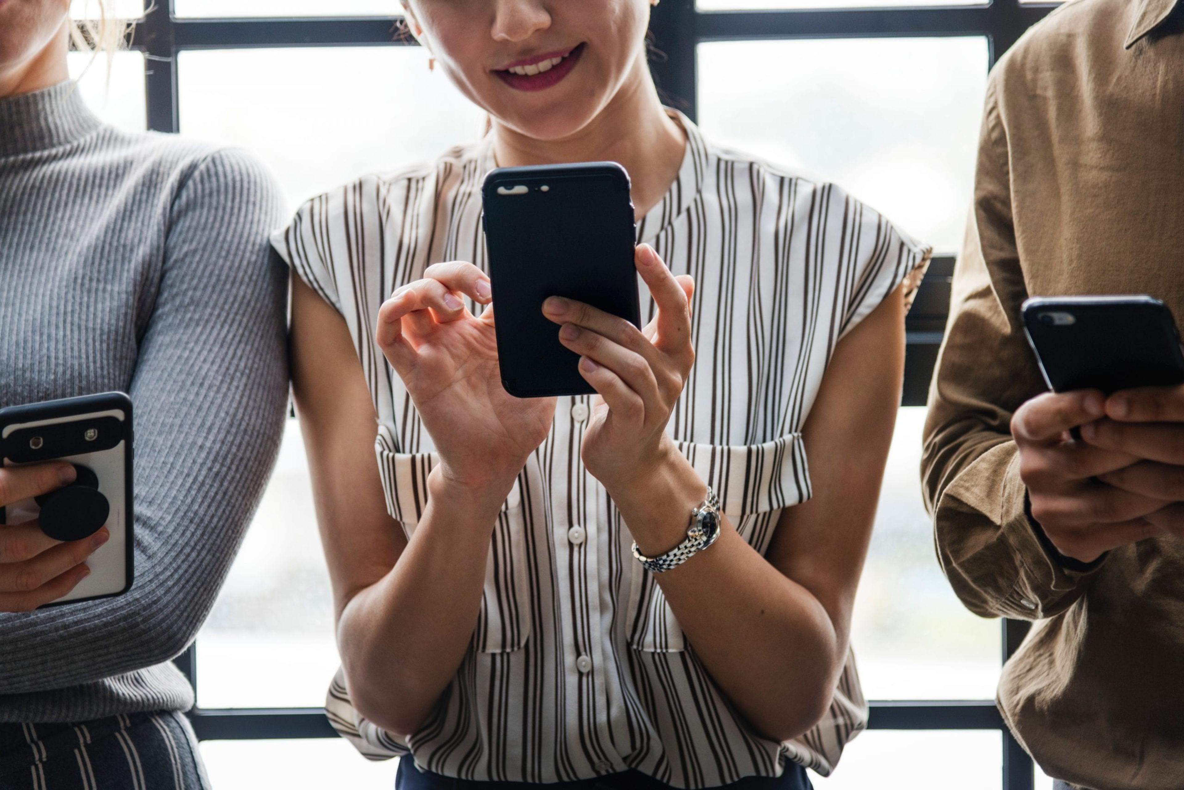 Three people on their smartphone