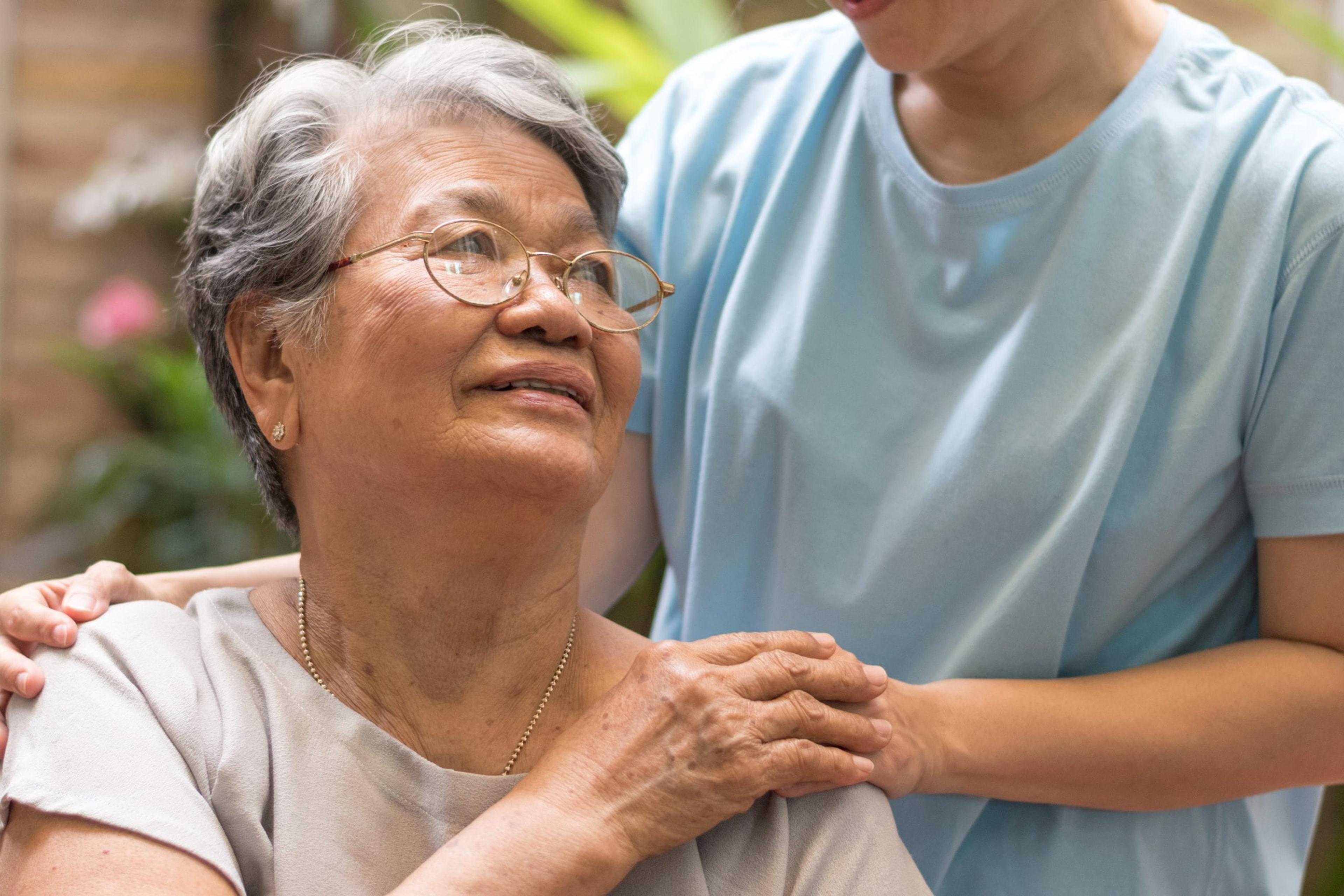 Woman holding the hand of a loved one