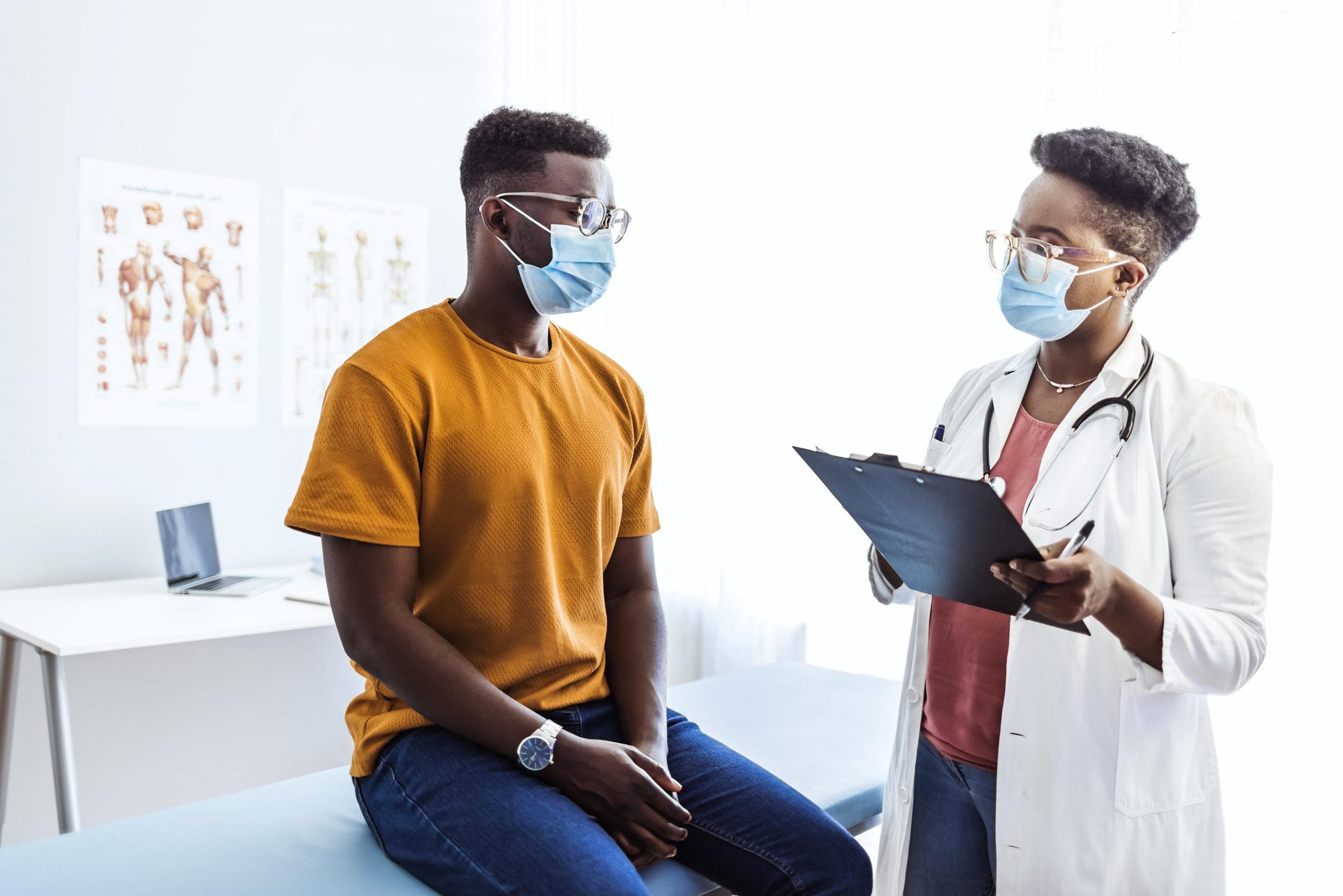 Doctor speaks to a male patient about behavioral health