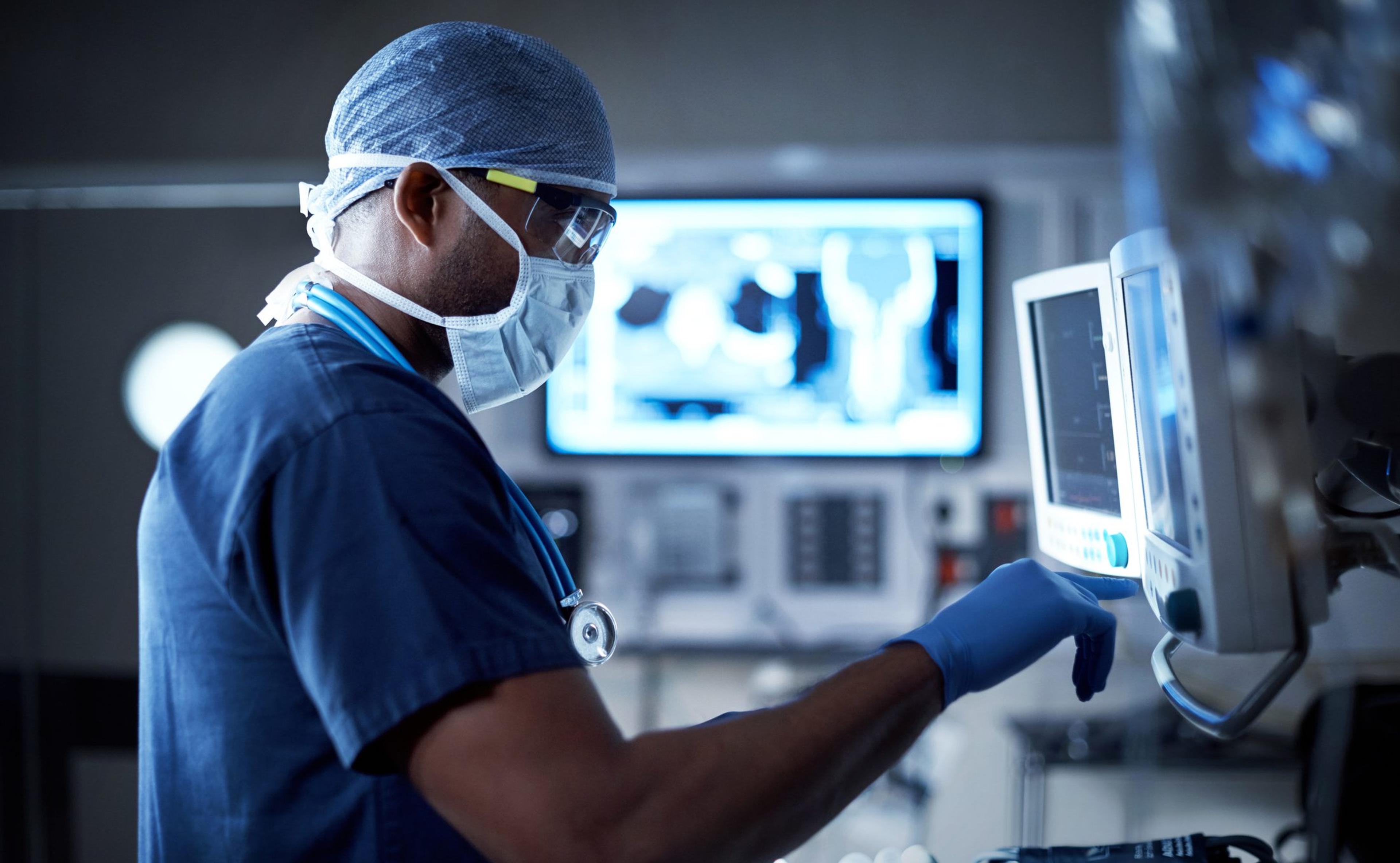 Surgeon reviewing x-rays and monitors