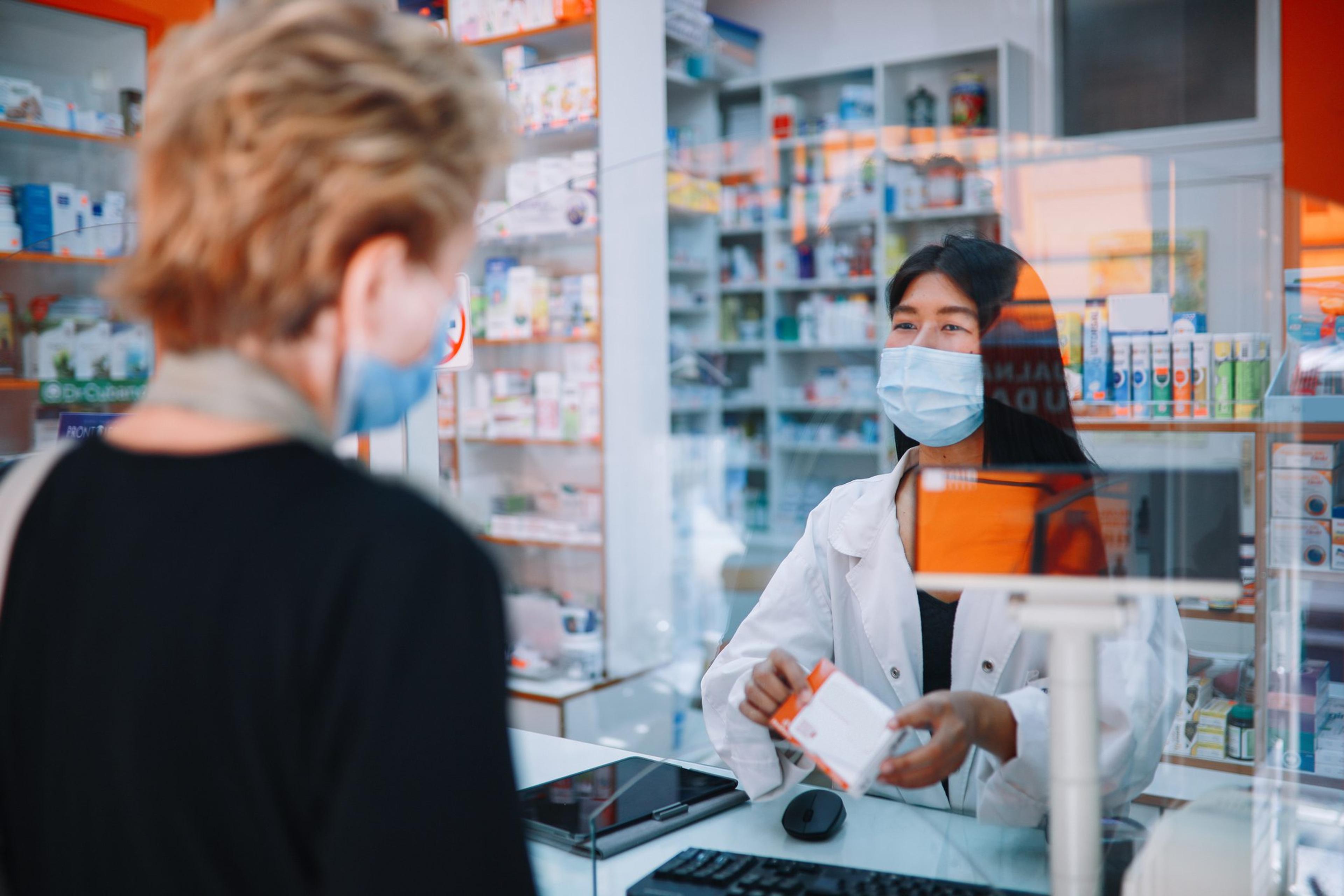 Senior customer buying medicine during the pandemic