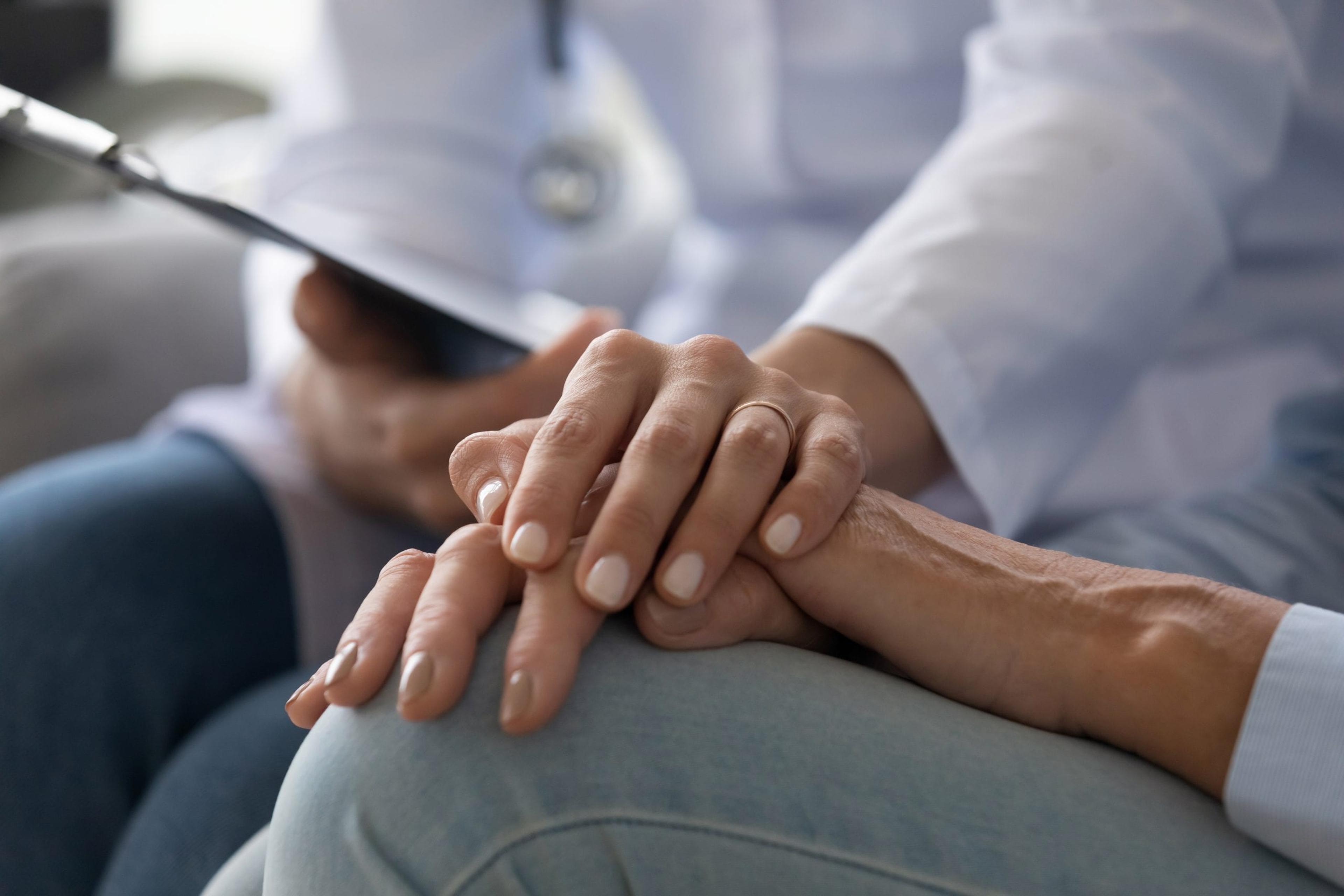 Doctor holding a patient's hand