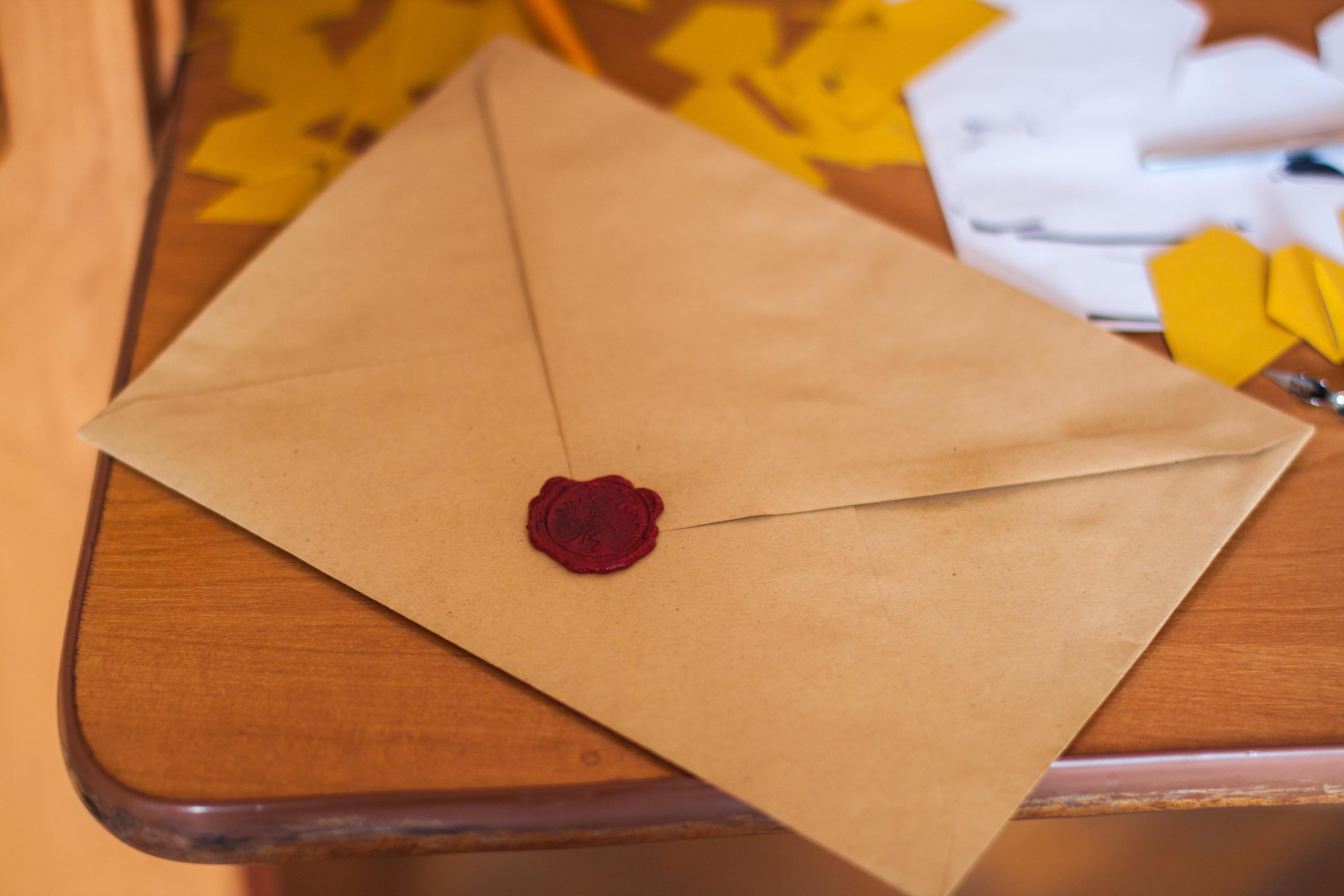closeup of a letter with a red wax seal.