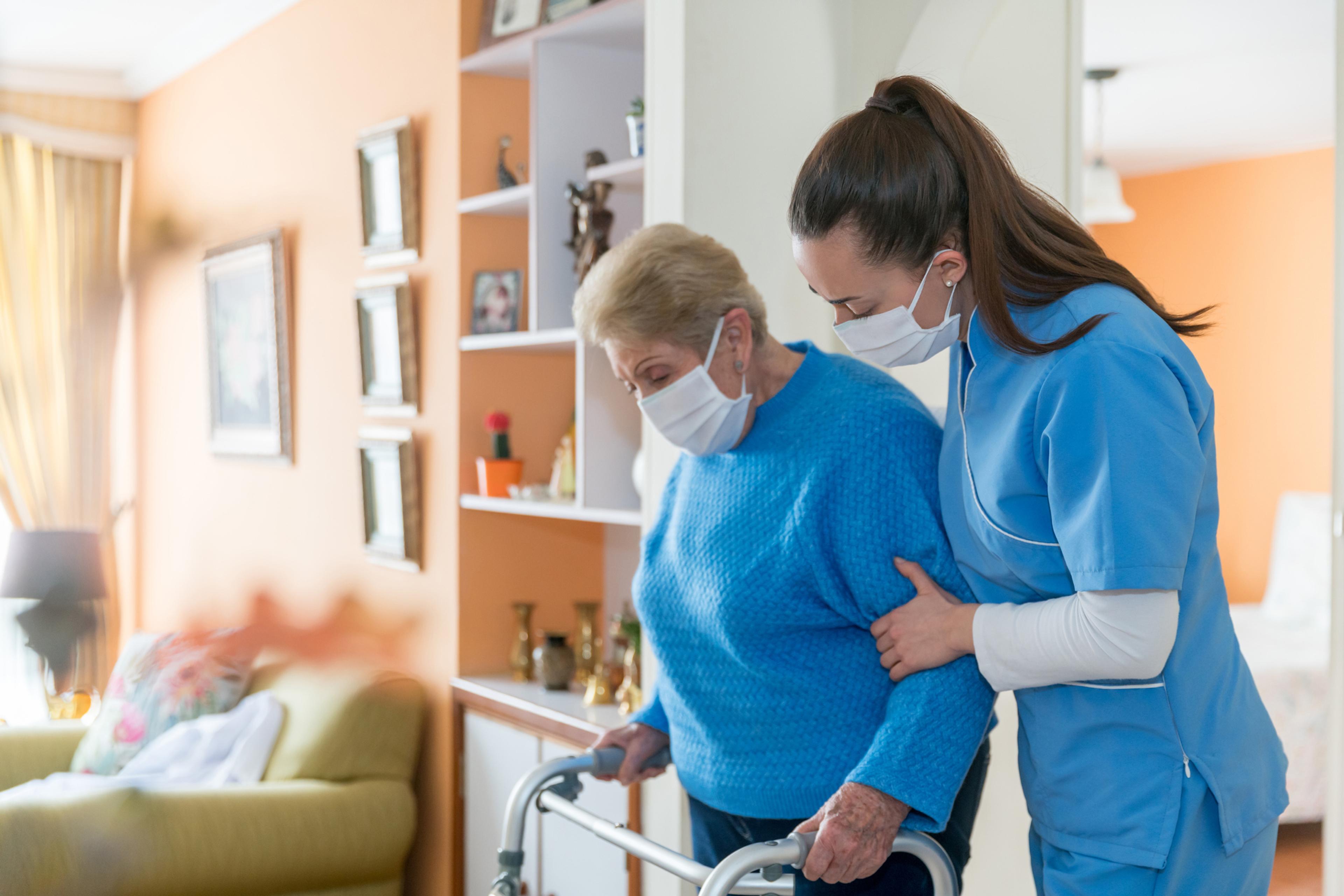 Nurse gives older female patient hospital care at home