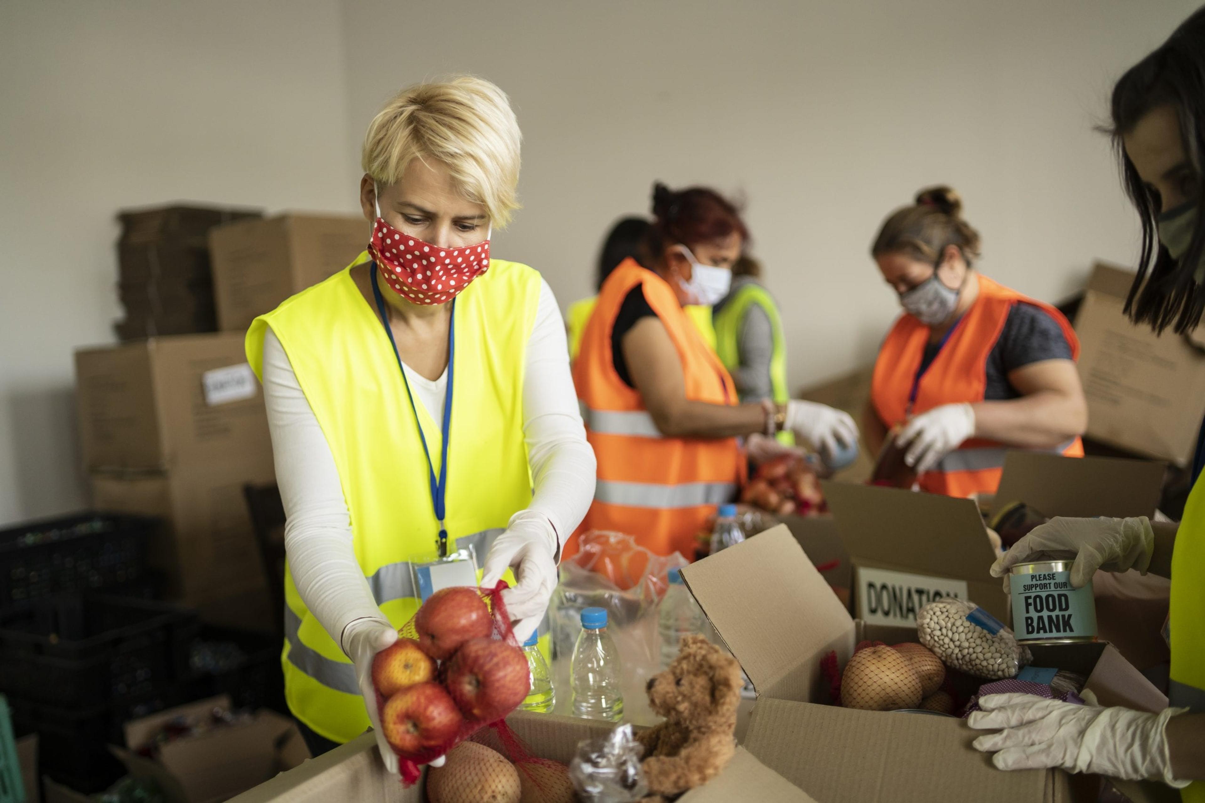 Woman wearing a mask packing food