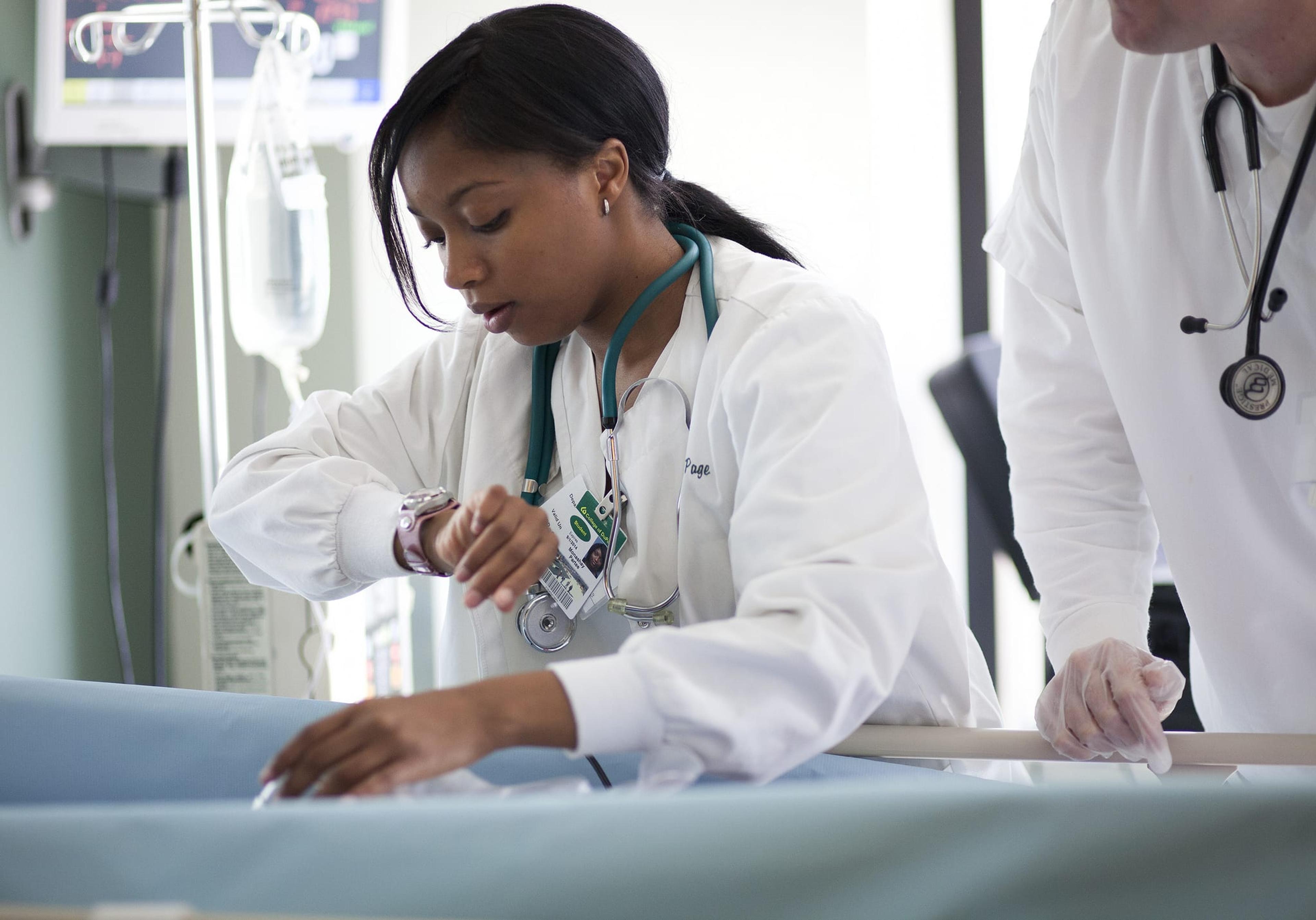 African American female doctor treating child in hospital