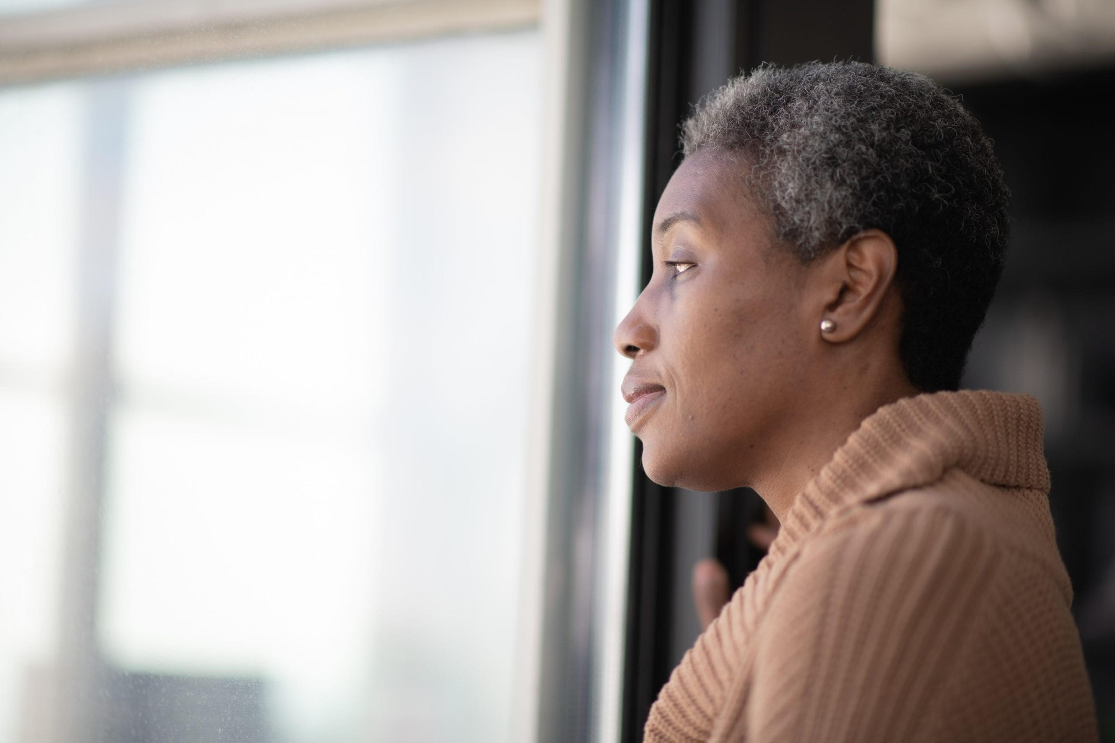 Older woman looking out the window