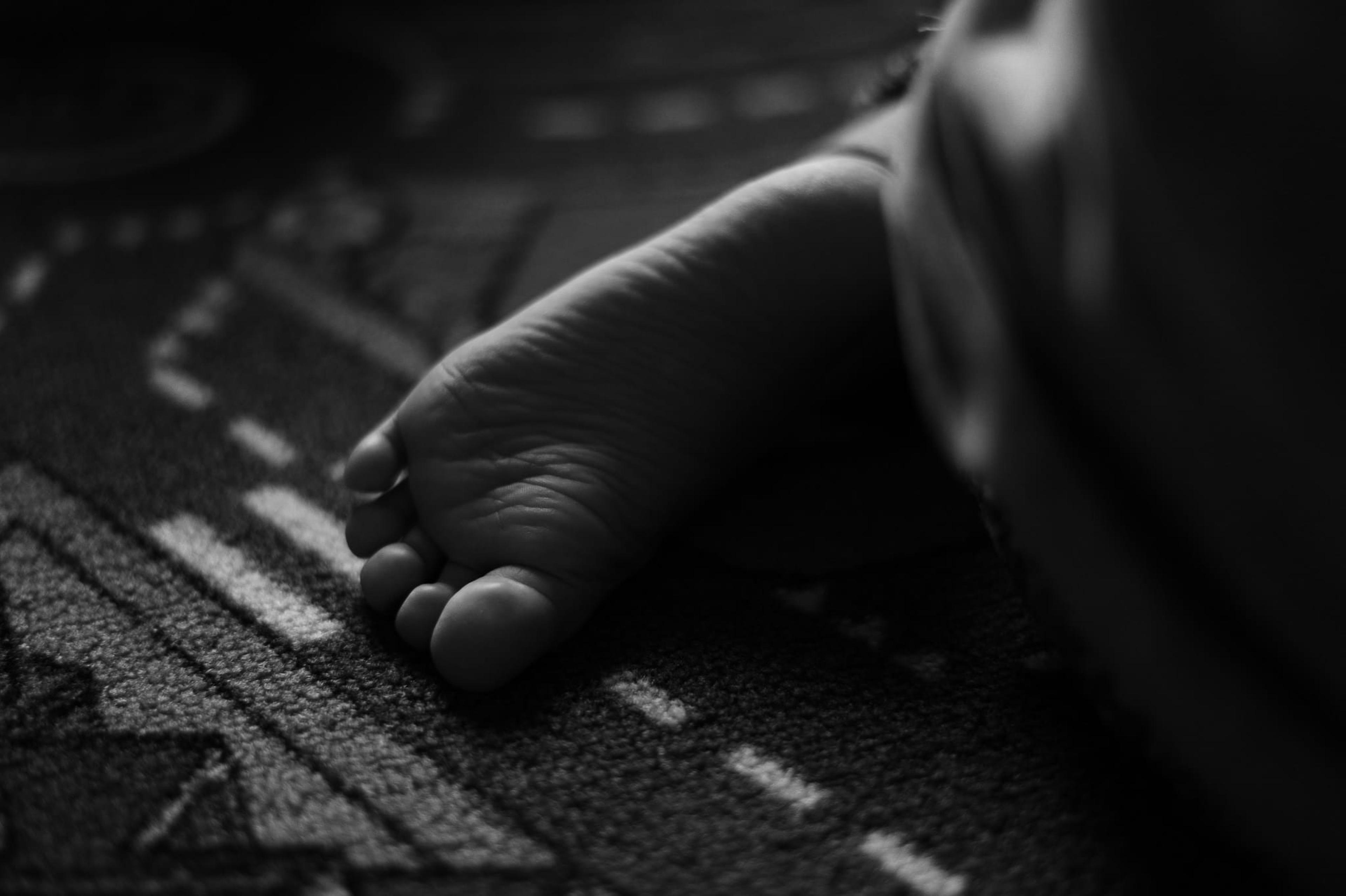 Black and white image of a baby's foot