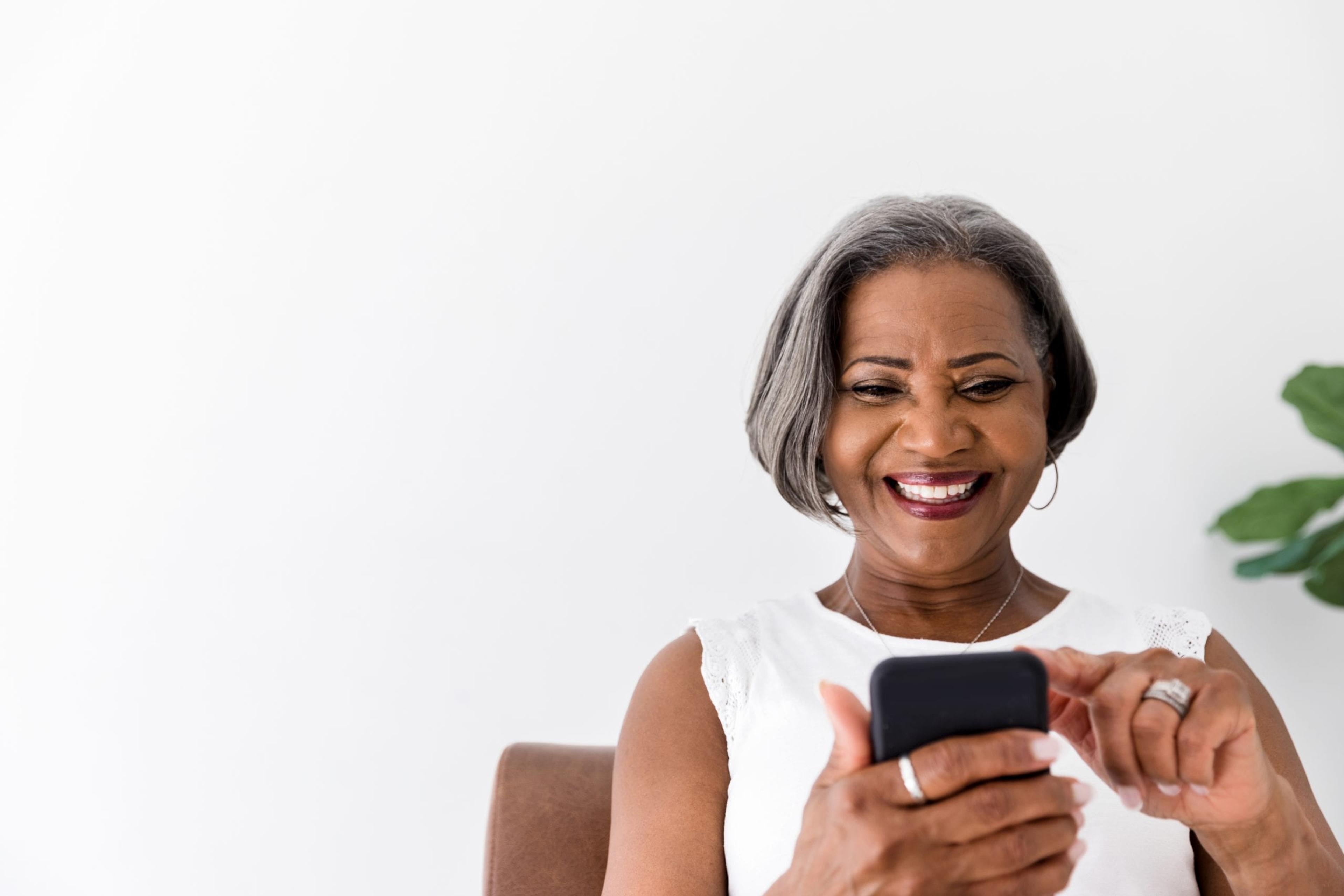 Older woman smiling at her smartphone