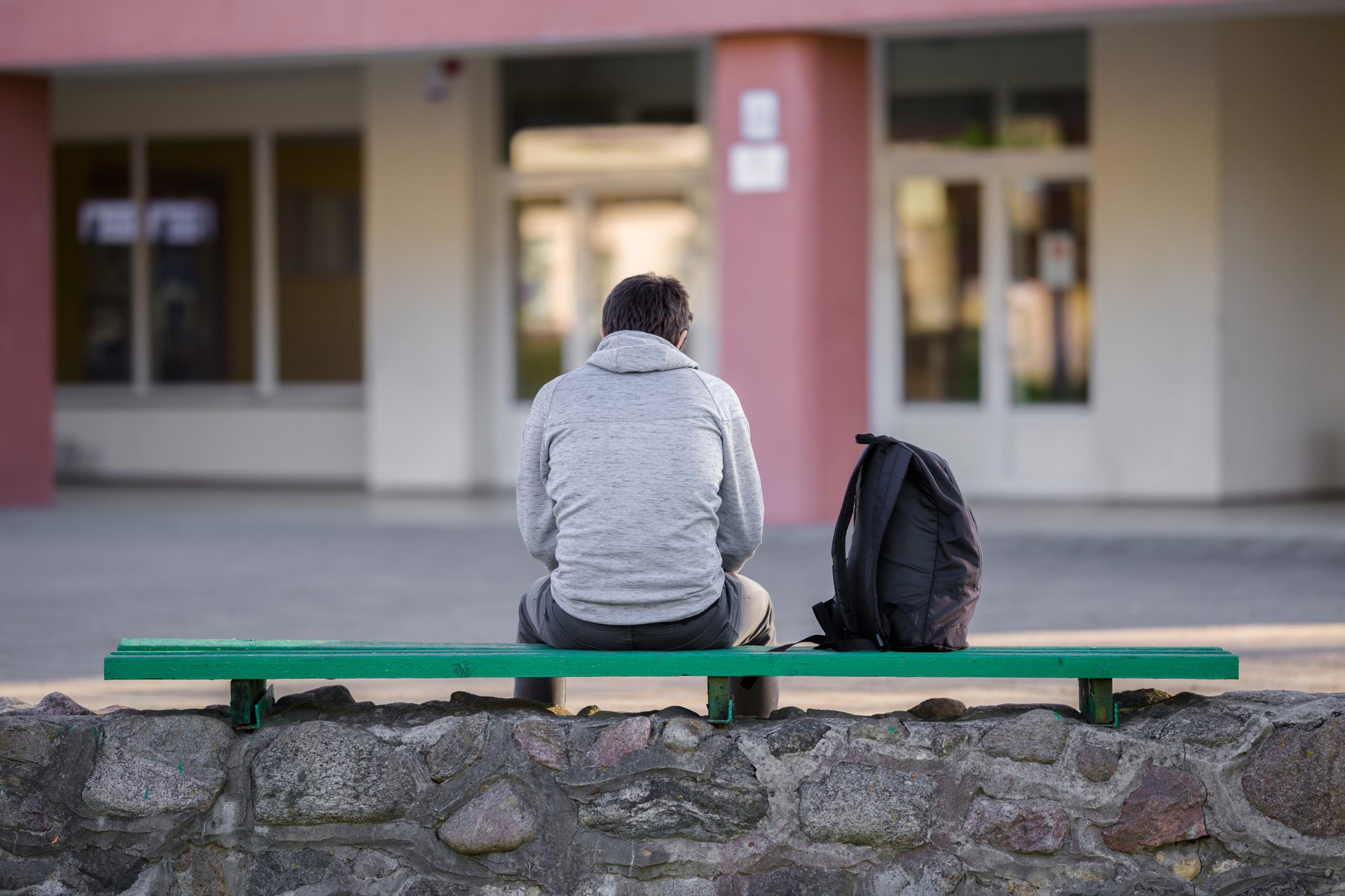 https://www.gettyimages.com/detail/photo/one-young-man-sitting-on-bench-at-school-yard-break-royalty-free-image/1227303349