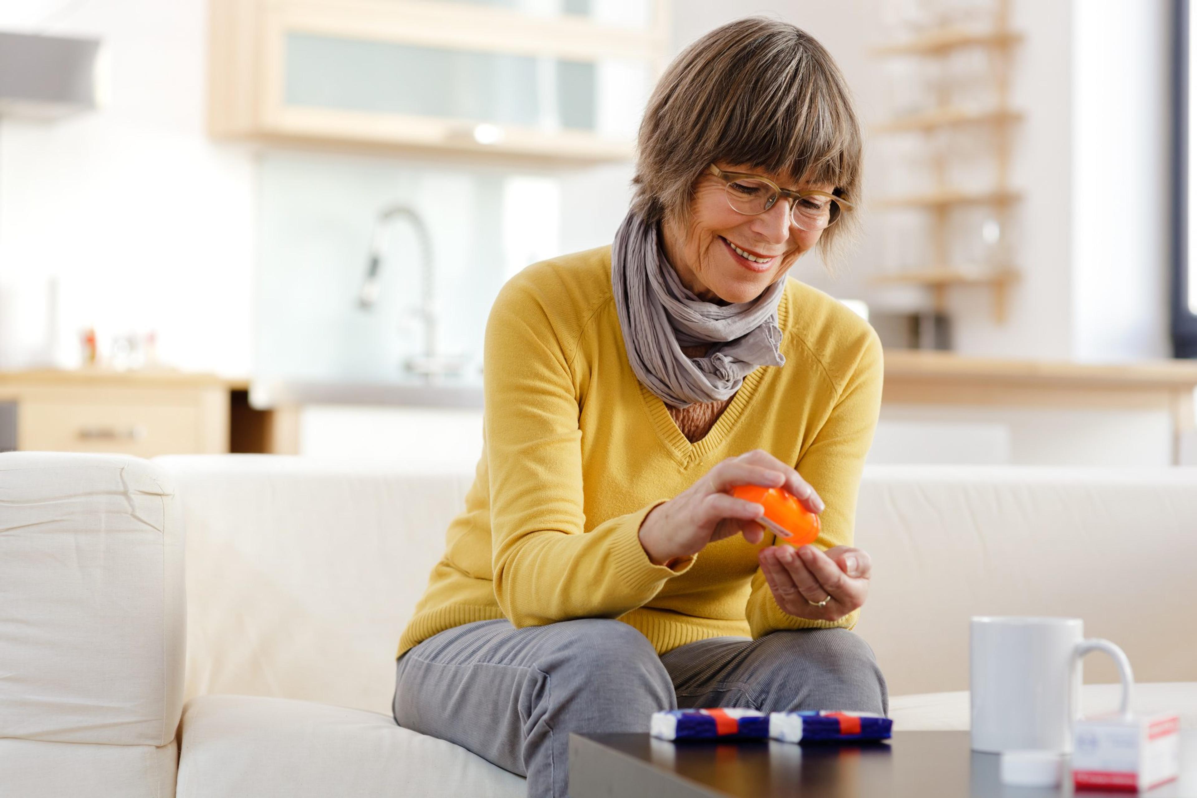 Woman looks at her medication