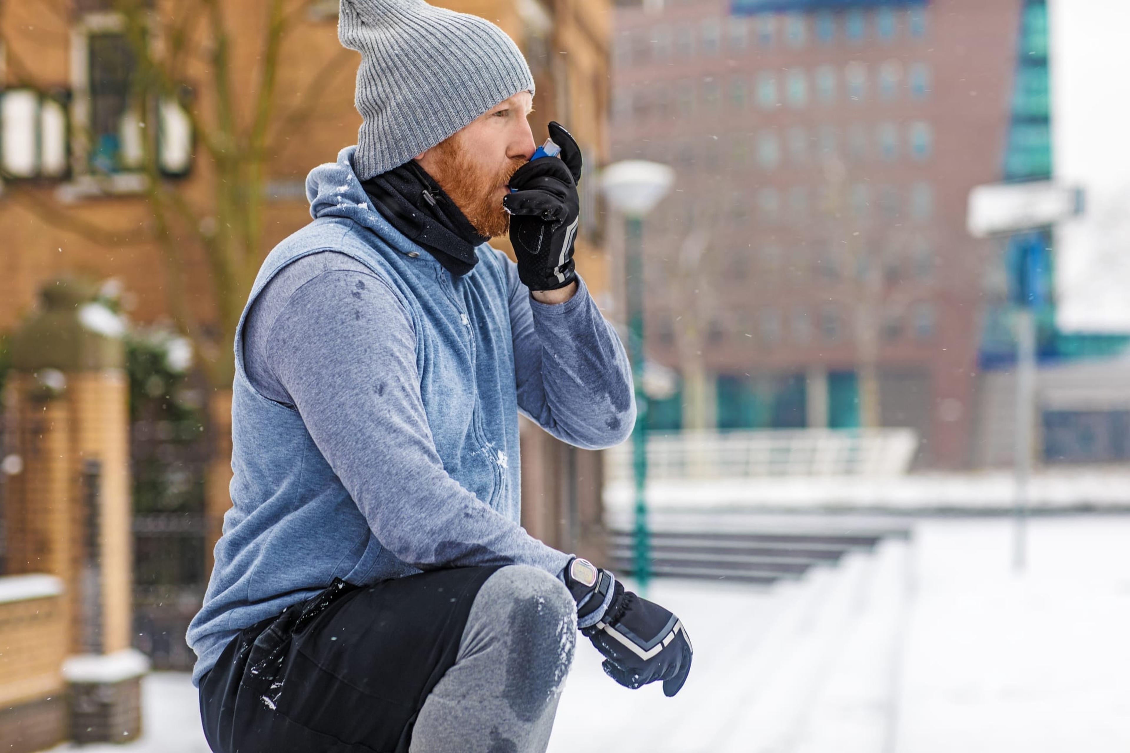 Man takes an inhaler for his asthma before runnign outside