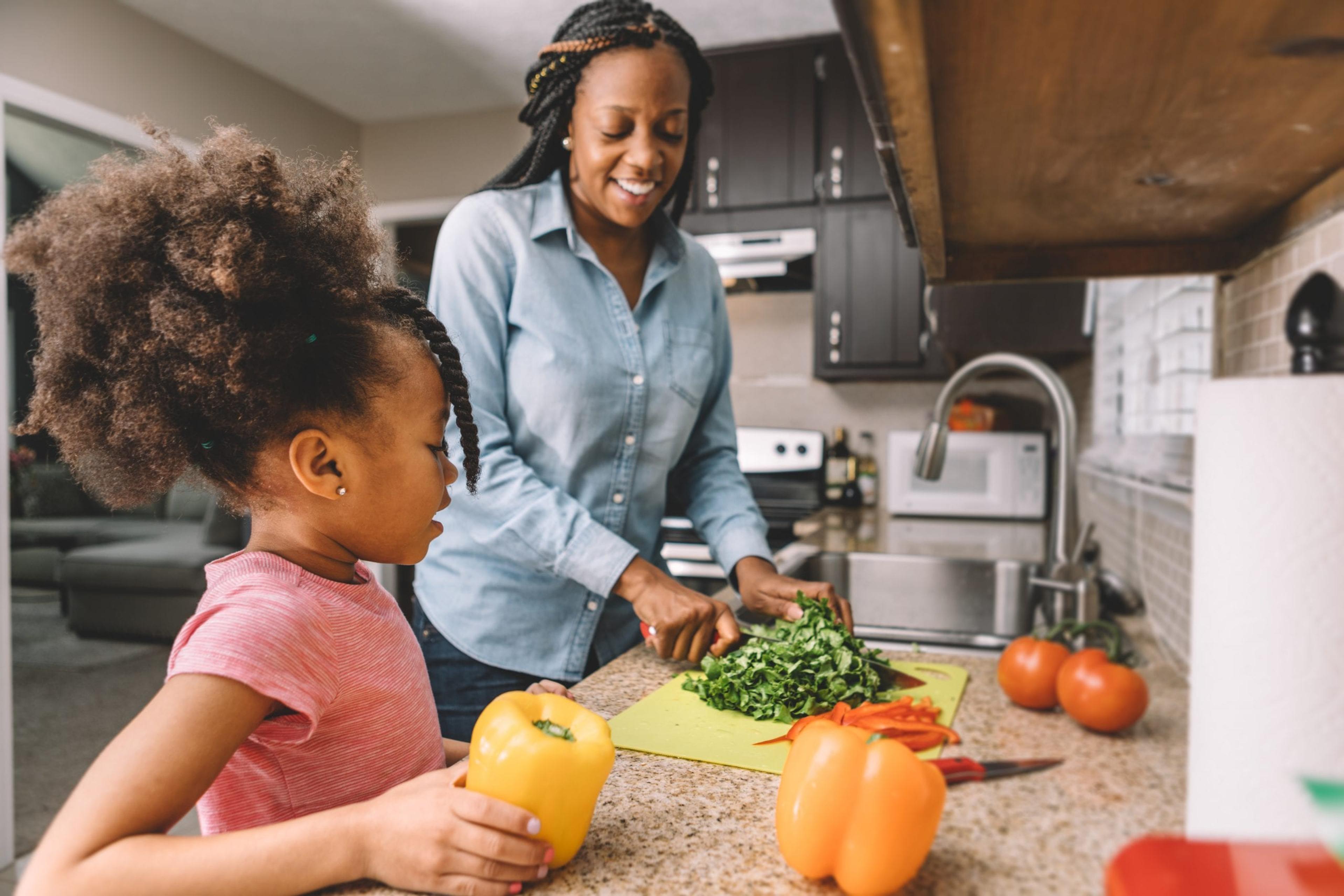 Mom making a salad with her daughter