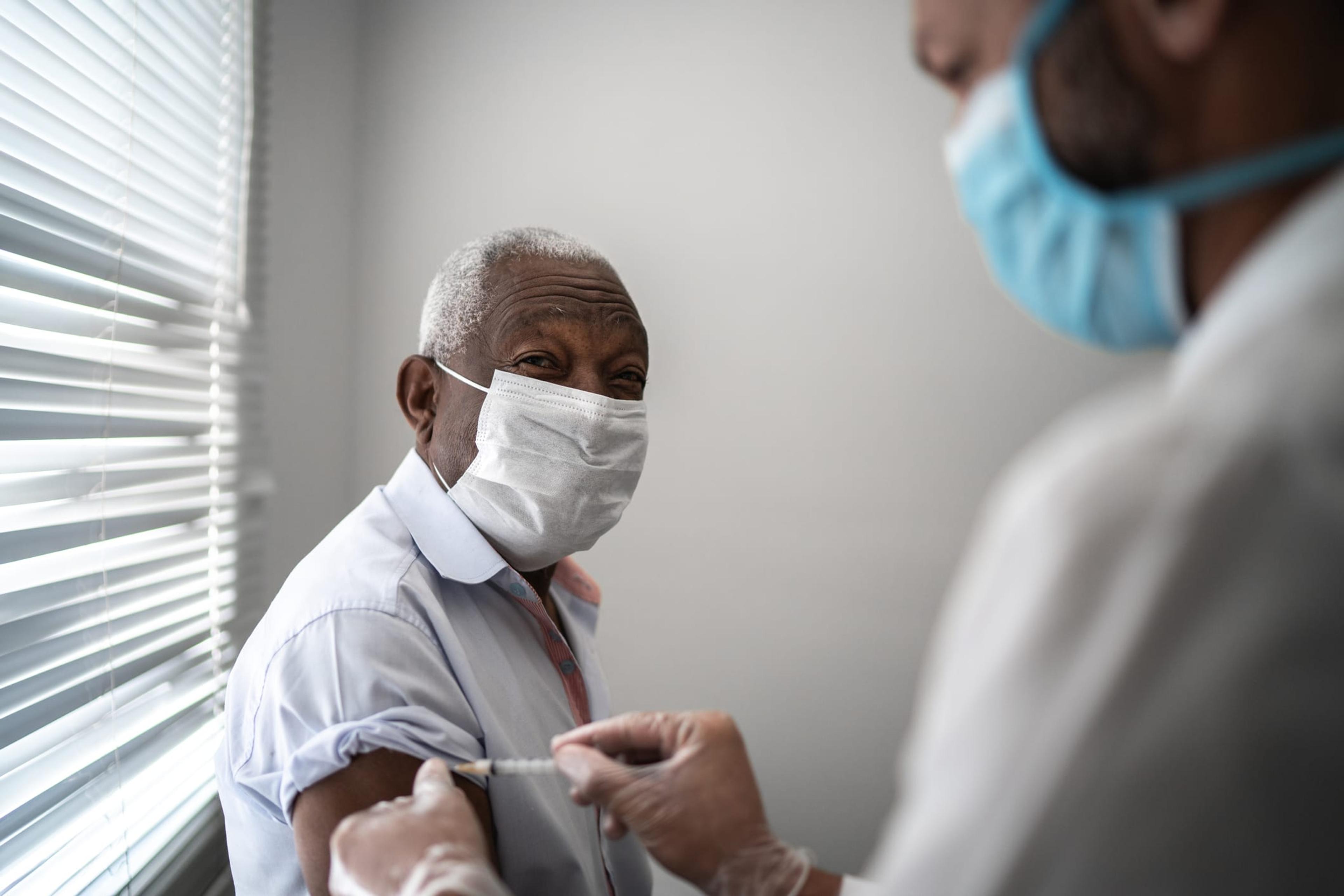 Patient receiving vaccine by medical professional.