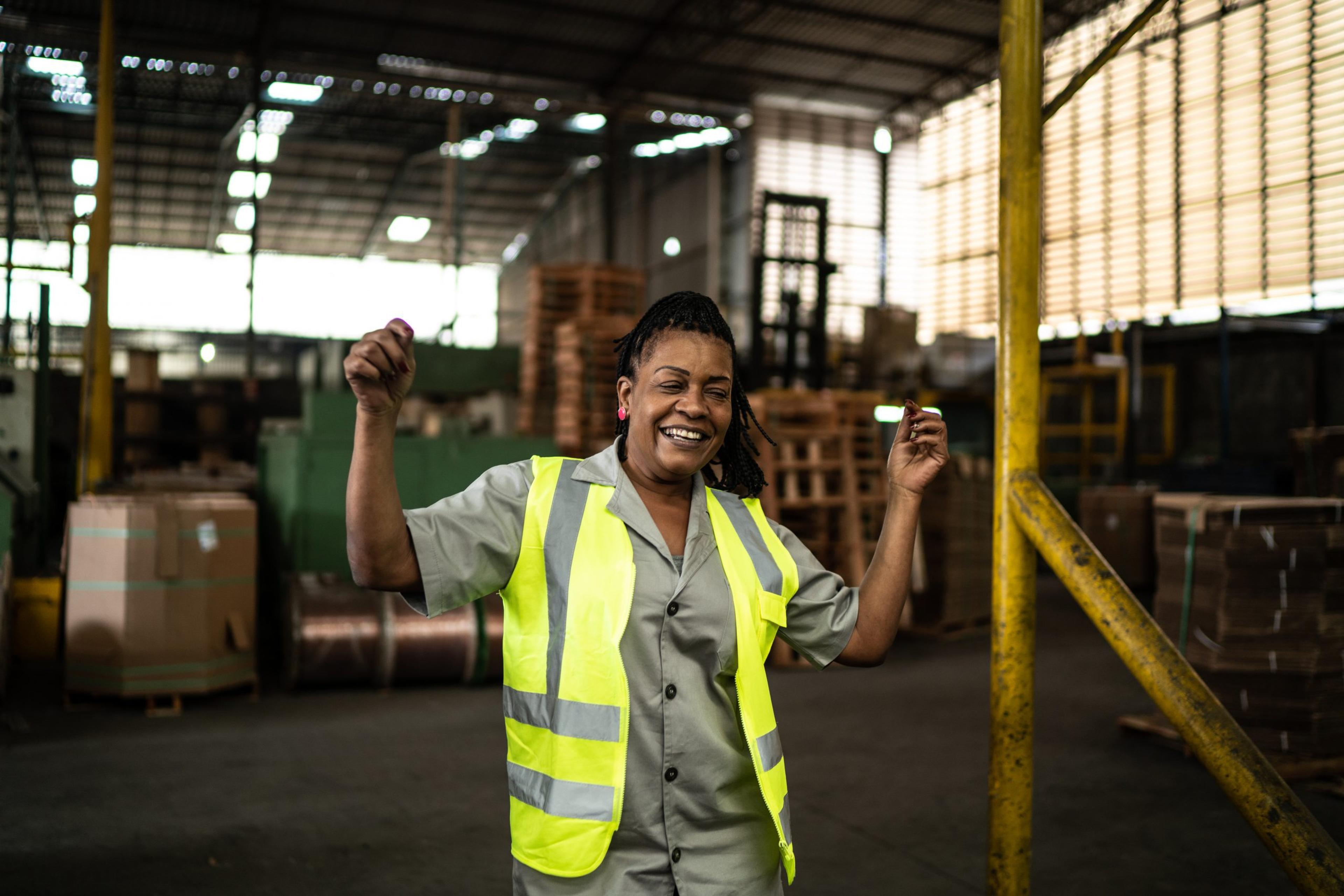 Happy mature woman dancing in a industry