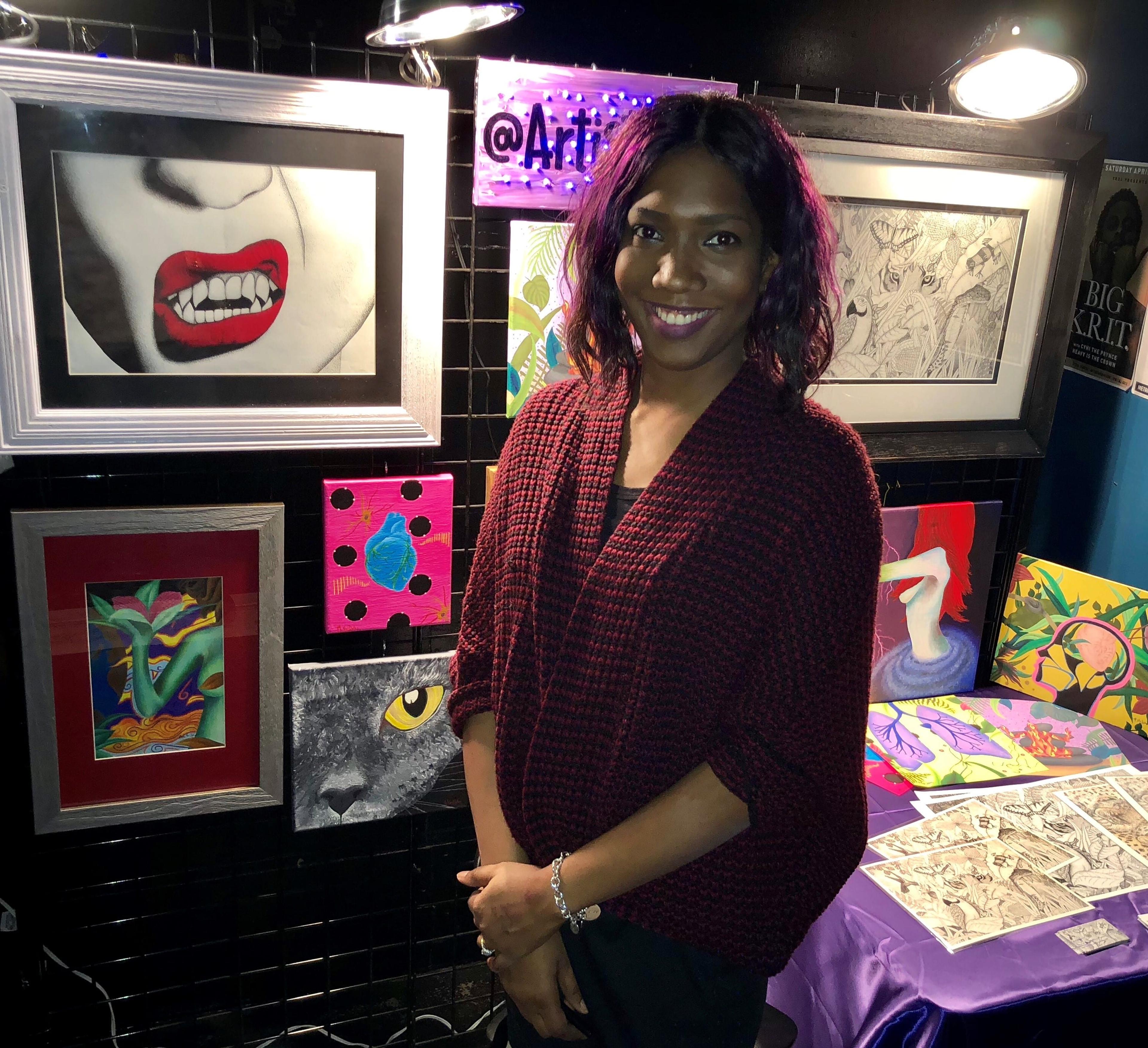 Image of Nicole Van Dyken in front of her artwork