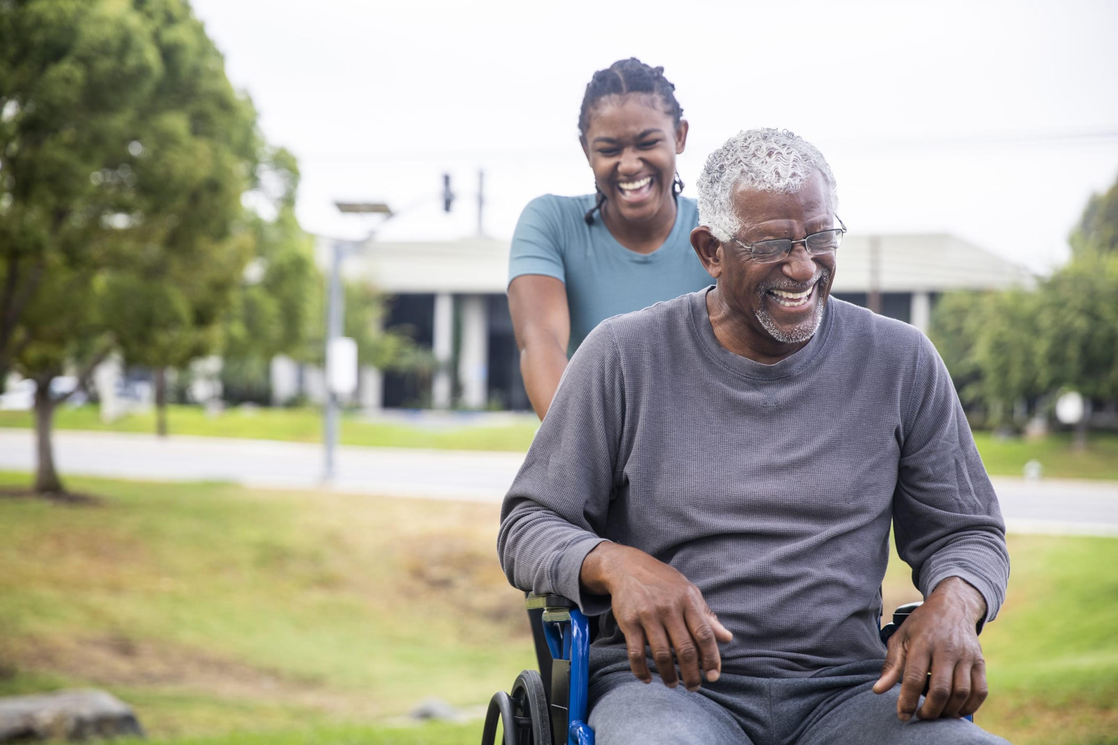 Senior black man in wheelchair with daughter