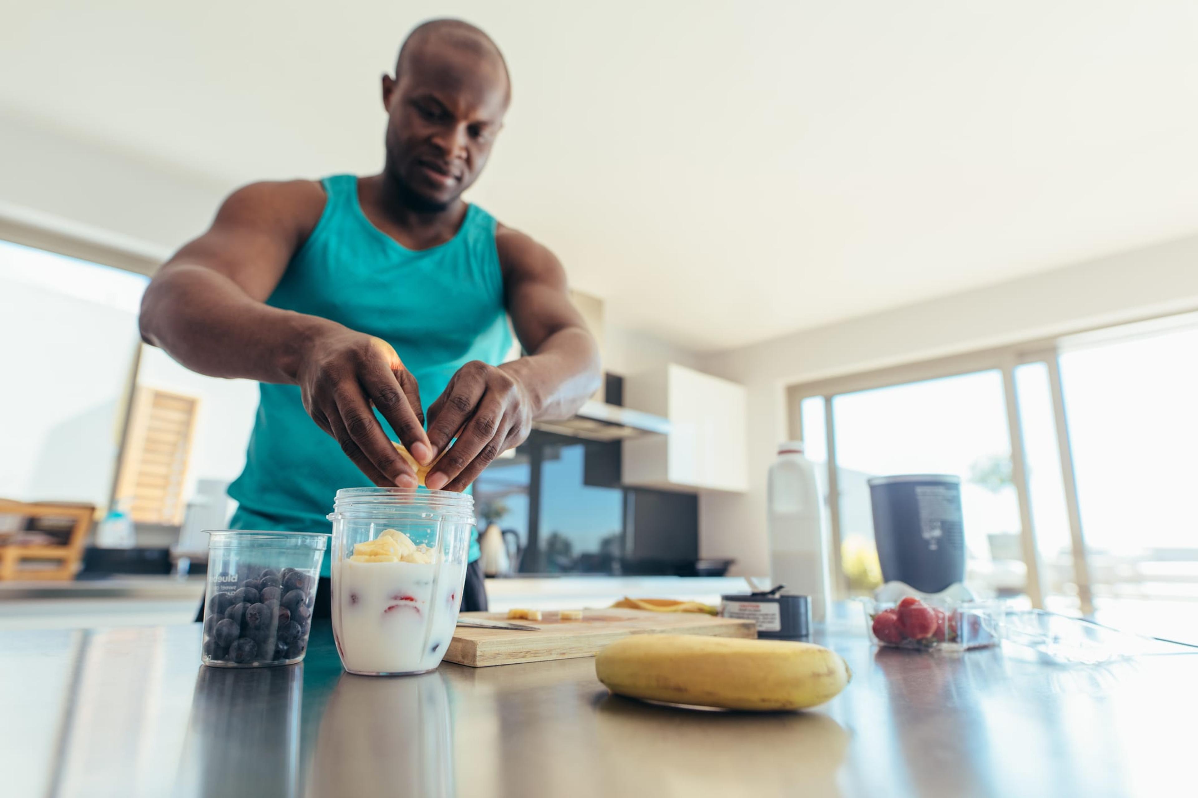 Man making a smoothie in his kitchen.