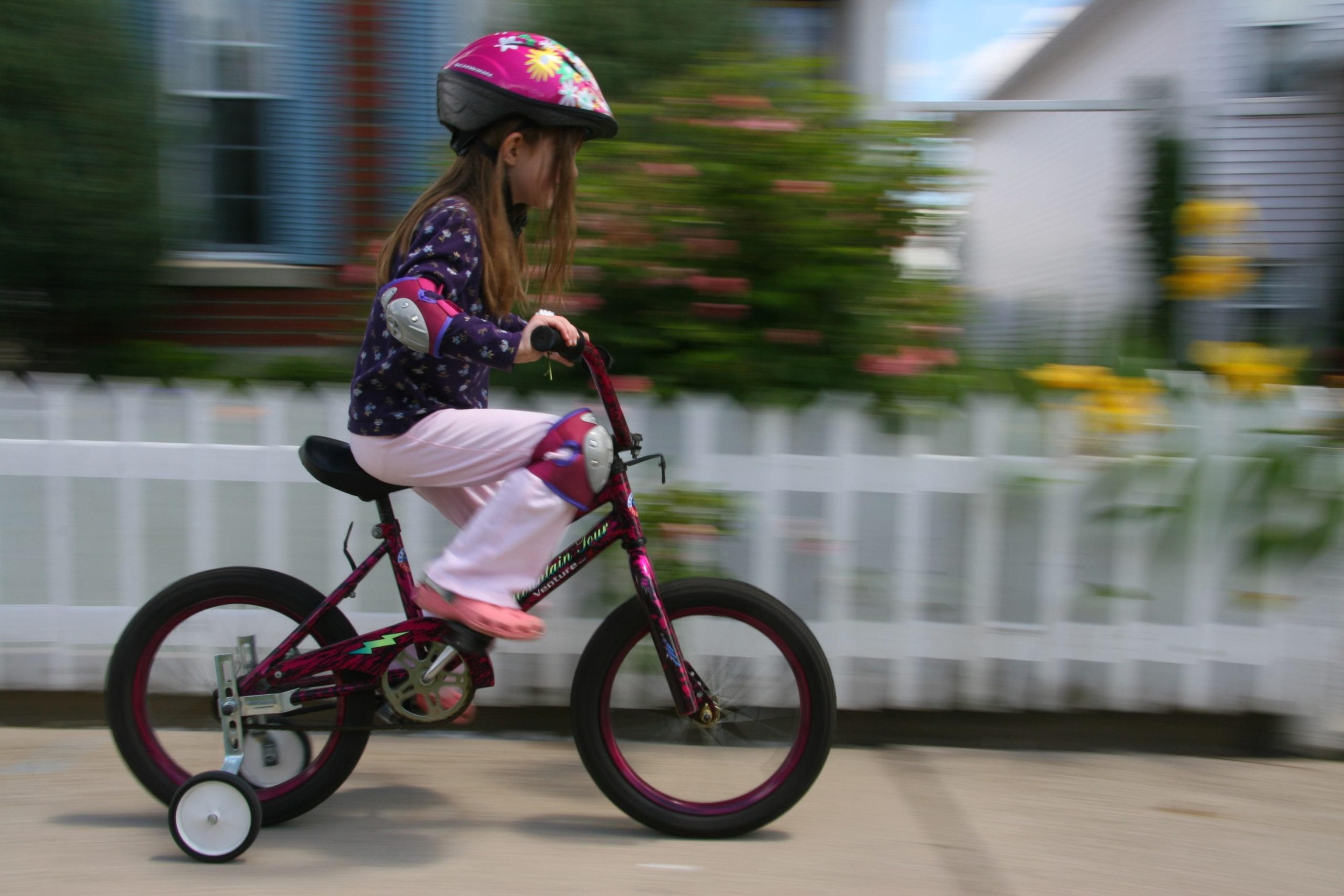 Little girl riding a bike.
