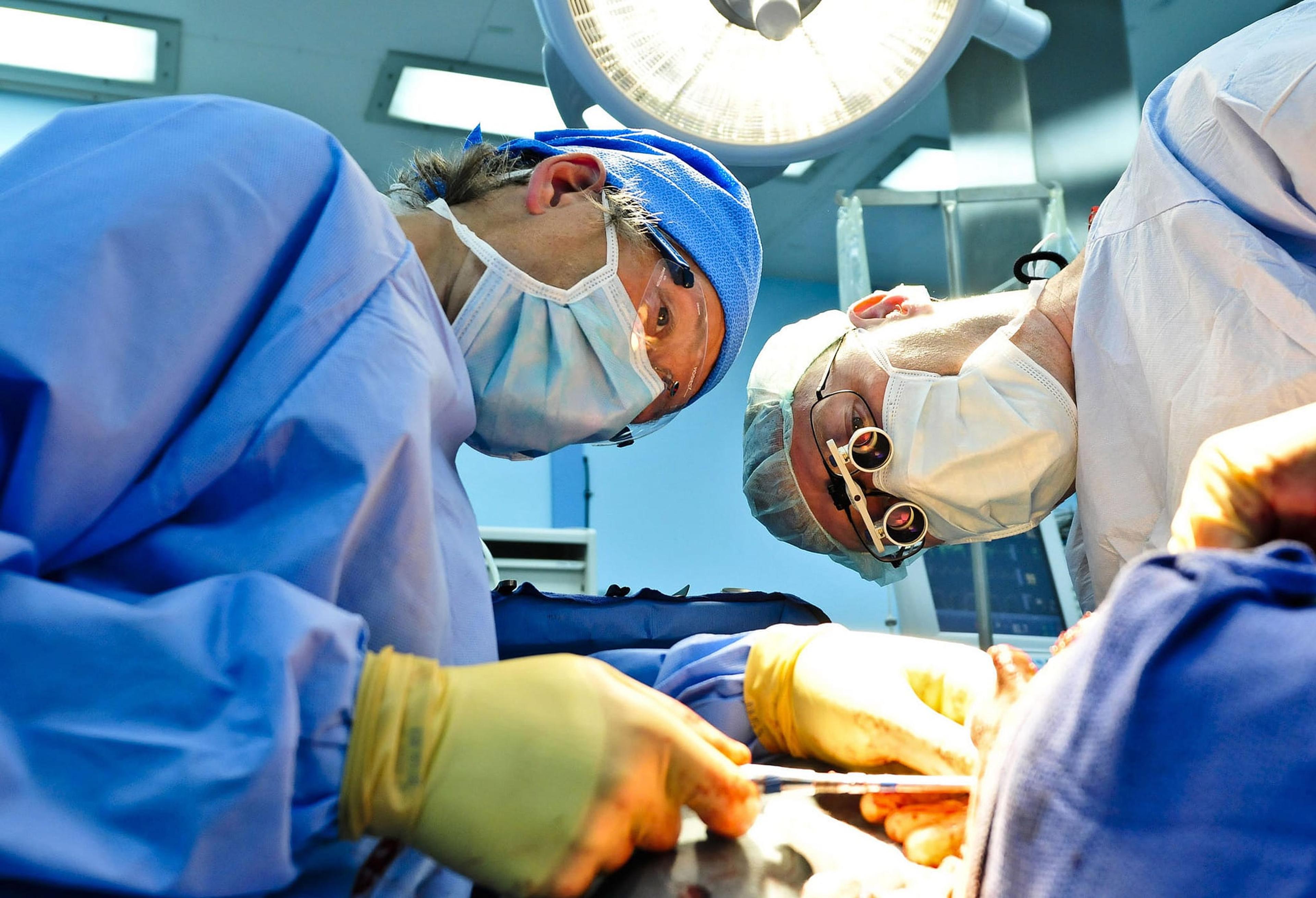 Two surgeons working on a patient.