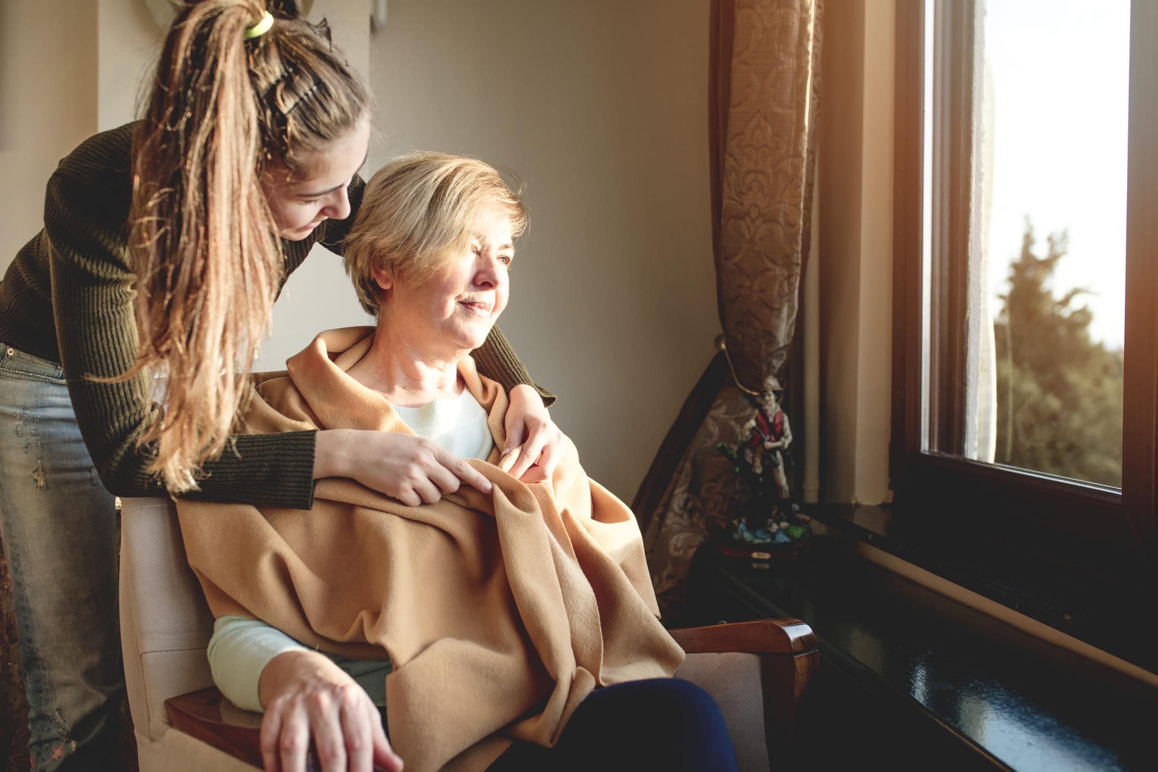 Younger woman caring for an older woman