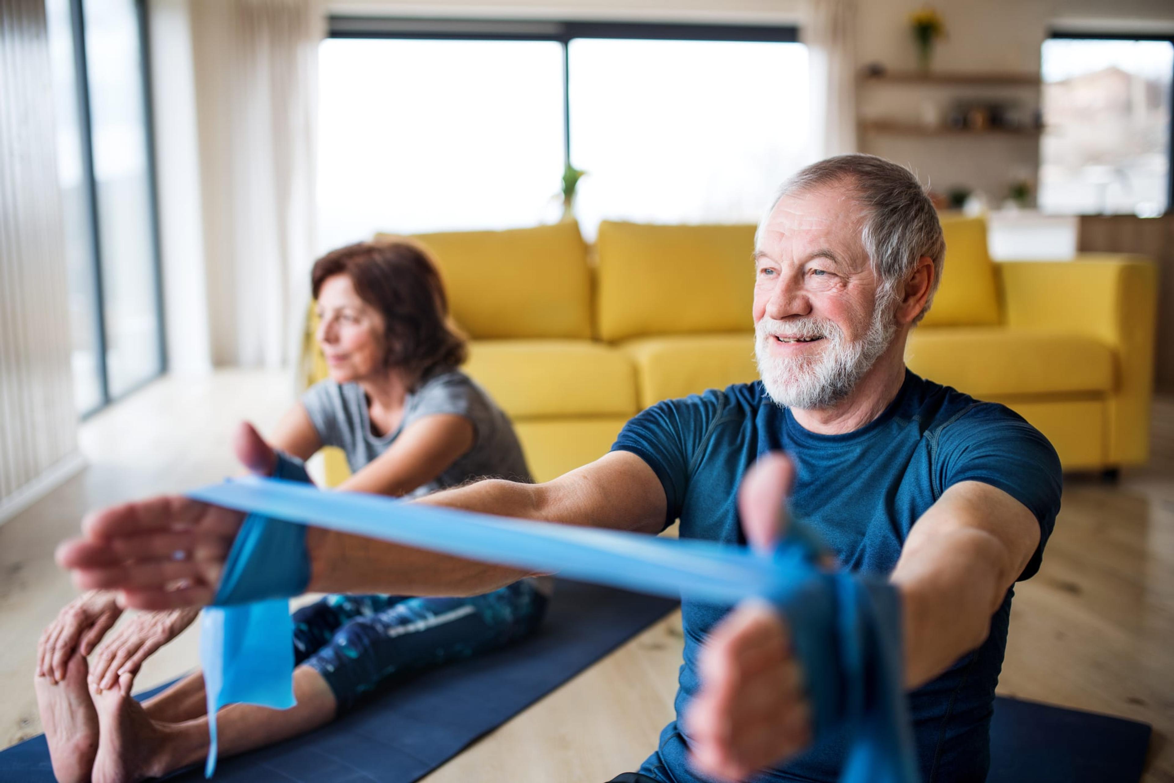 A couple exercise indoors