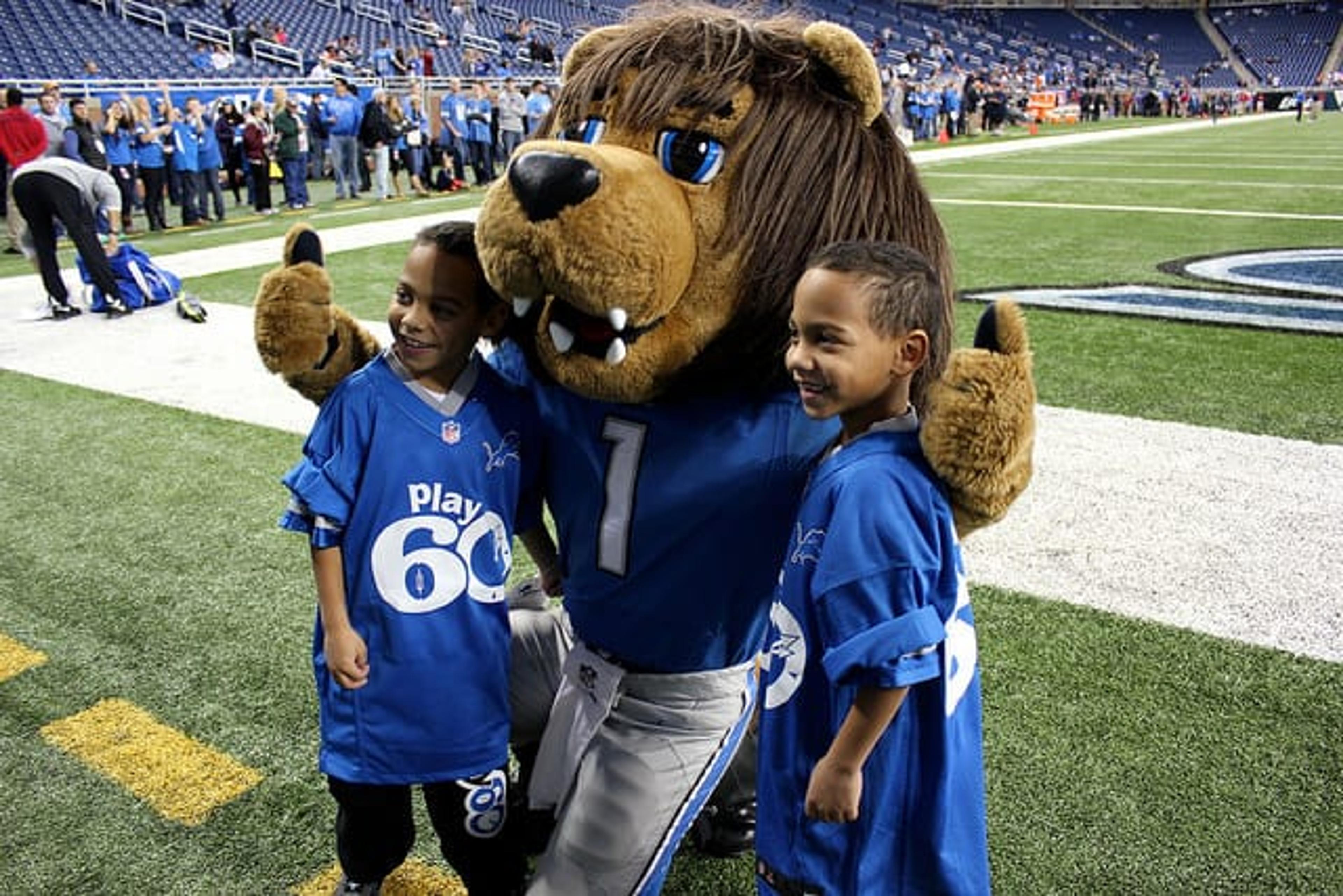 Roary the Lion posing with kids at a Detroit Lions game.