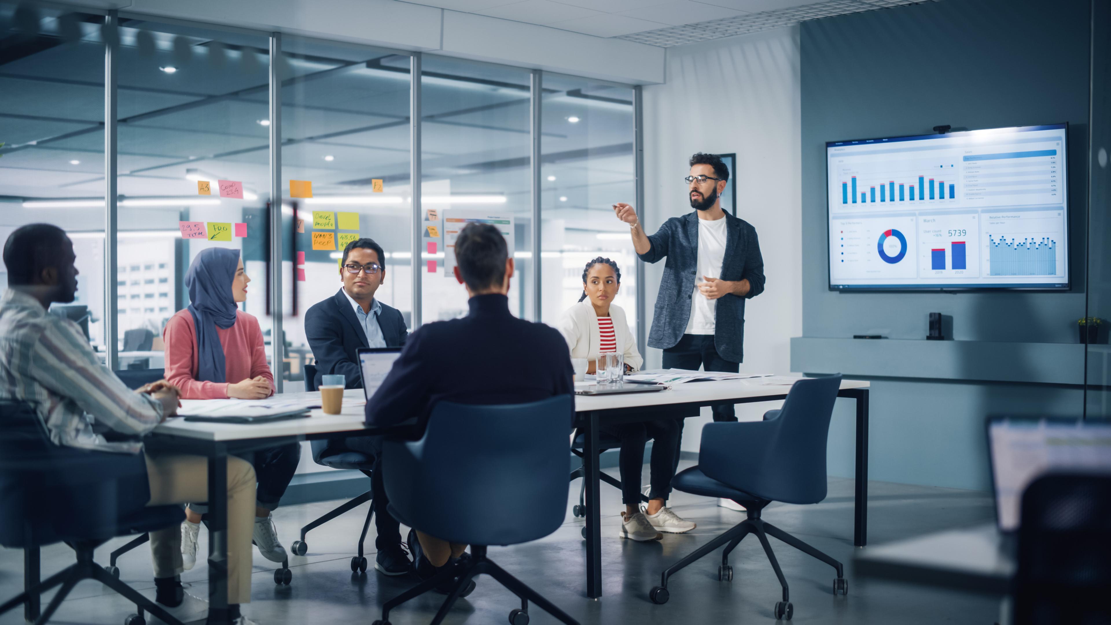 group of employees gather around a conference table at work