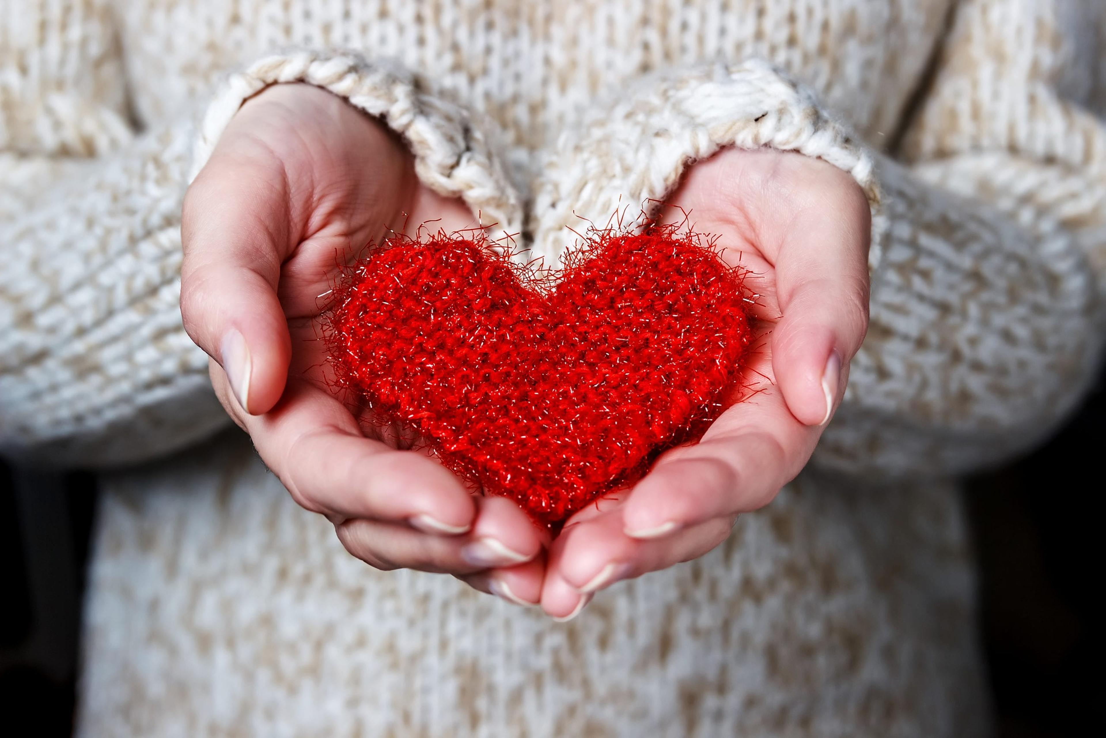 Girl holding a red knitted heart