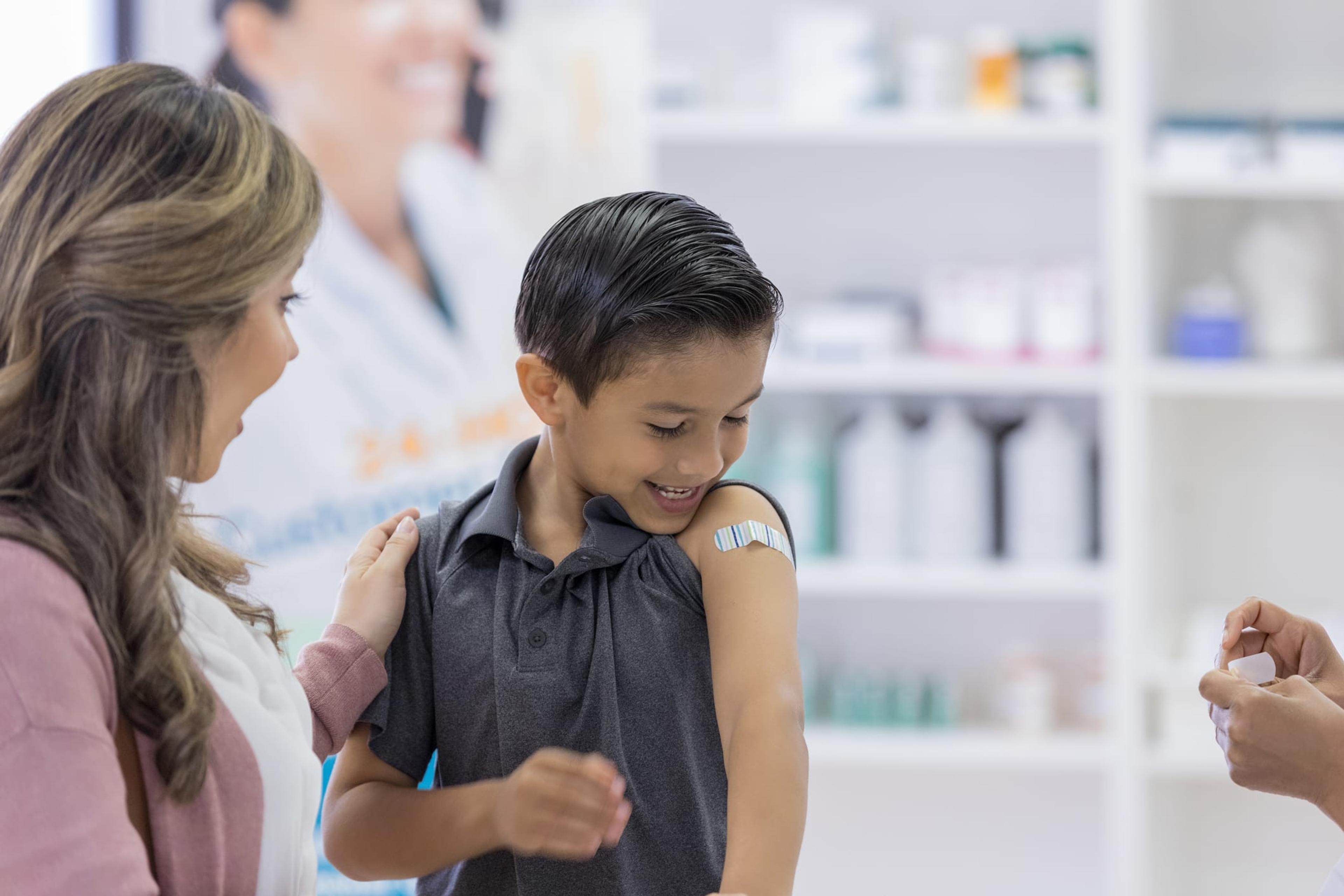 Young boy receives bandage after vaccine