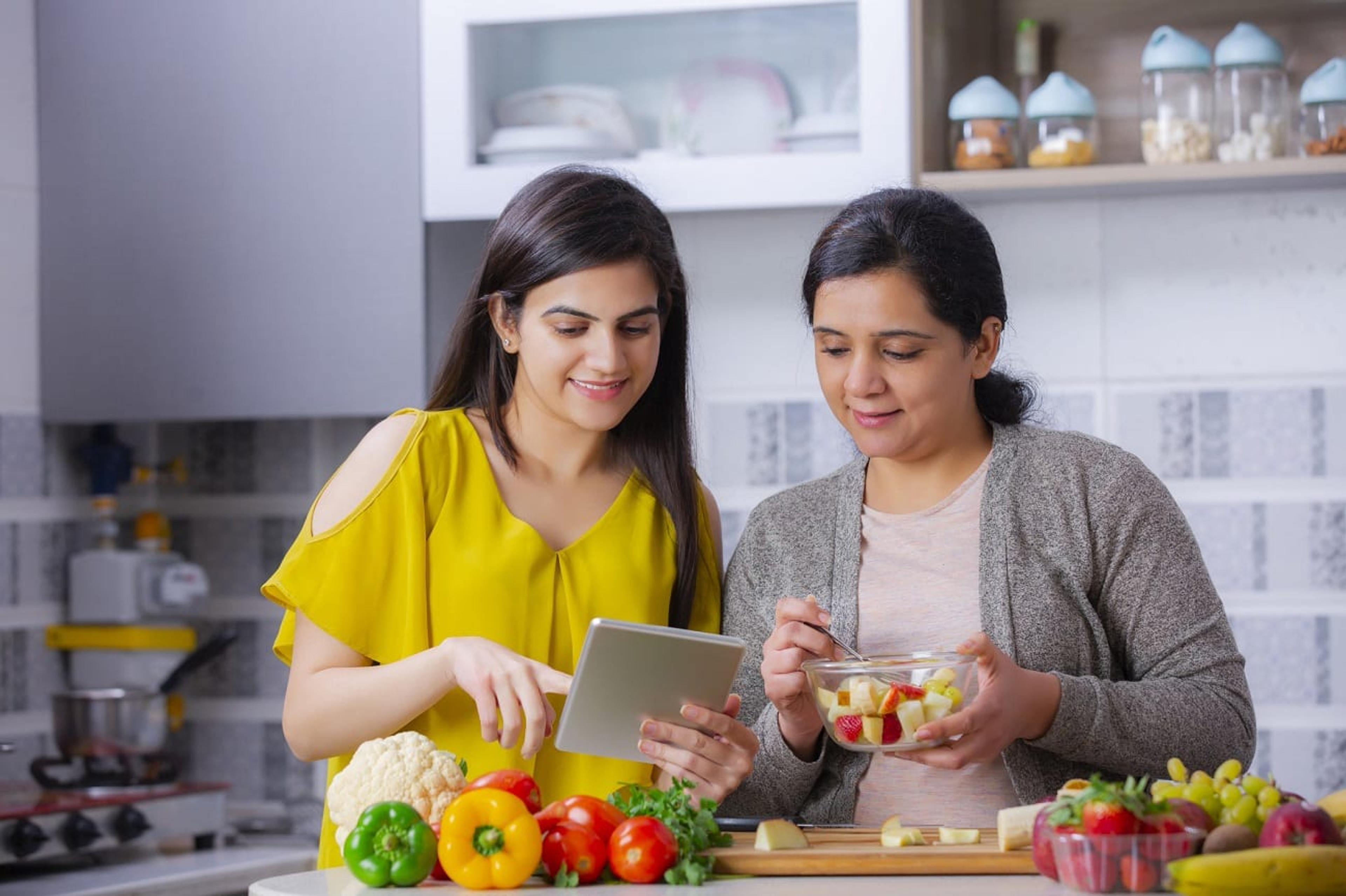 Indian mother and daughter cook in the kitchen