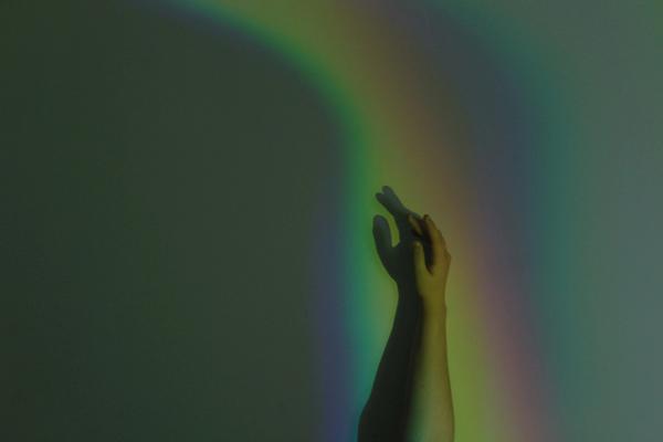 Hand on wall with rainbow