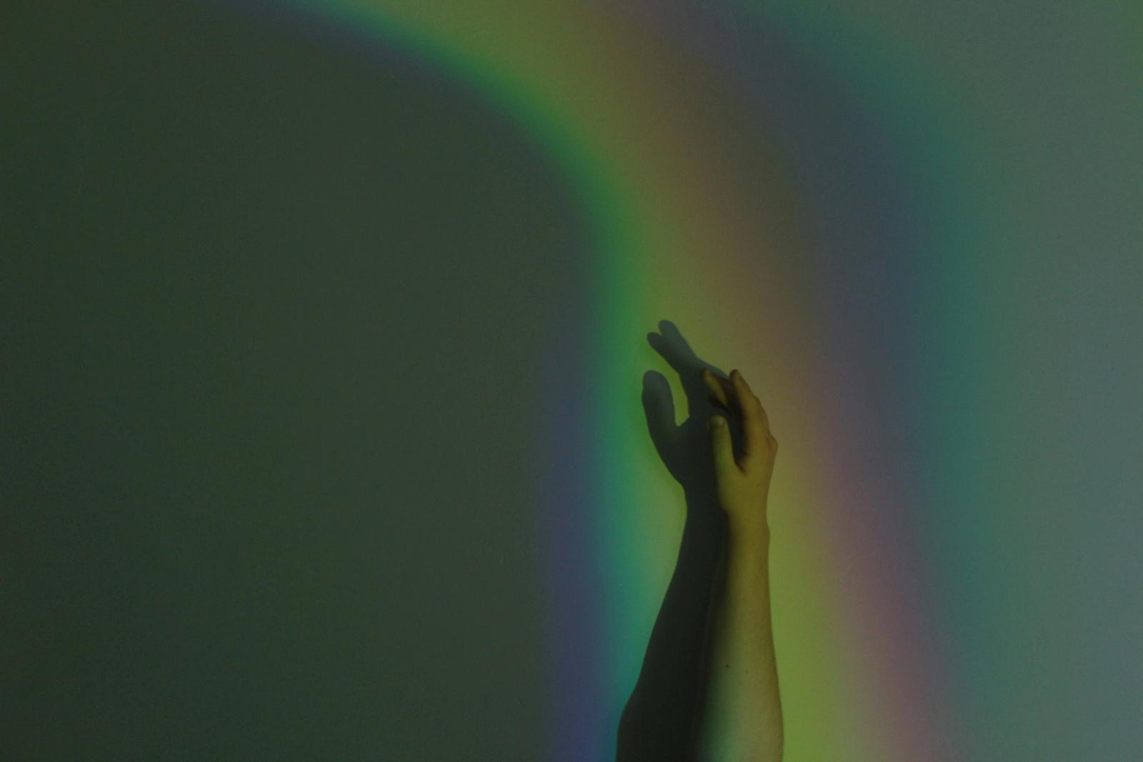 Hand on wall with rainbow