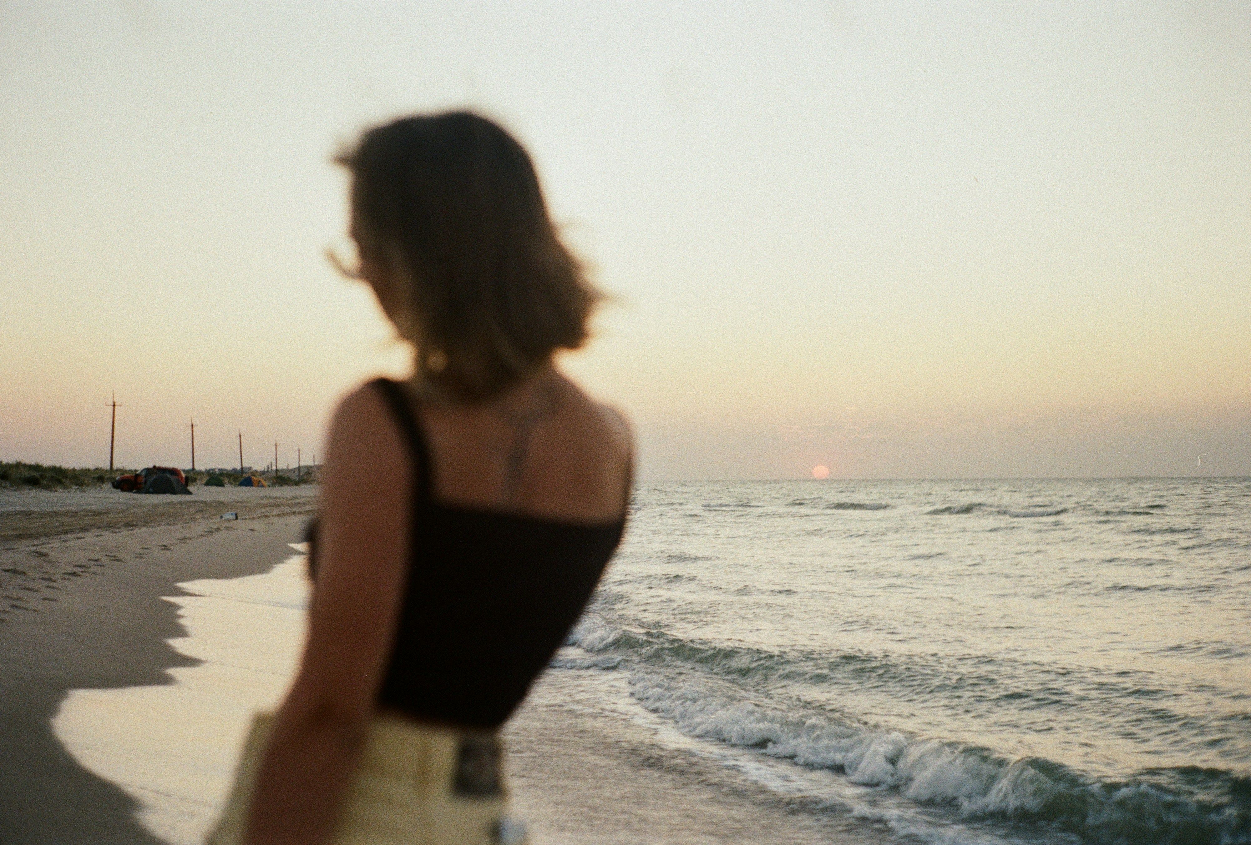 Woman's back looking at ocean