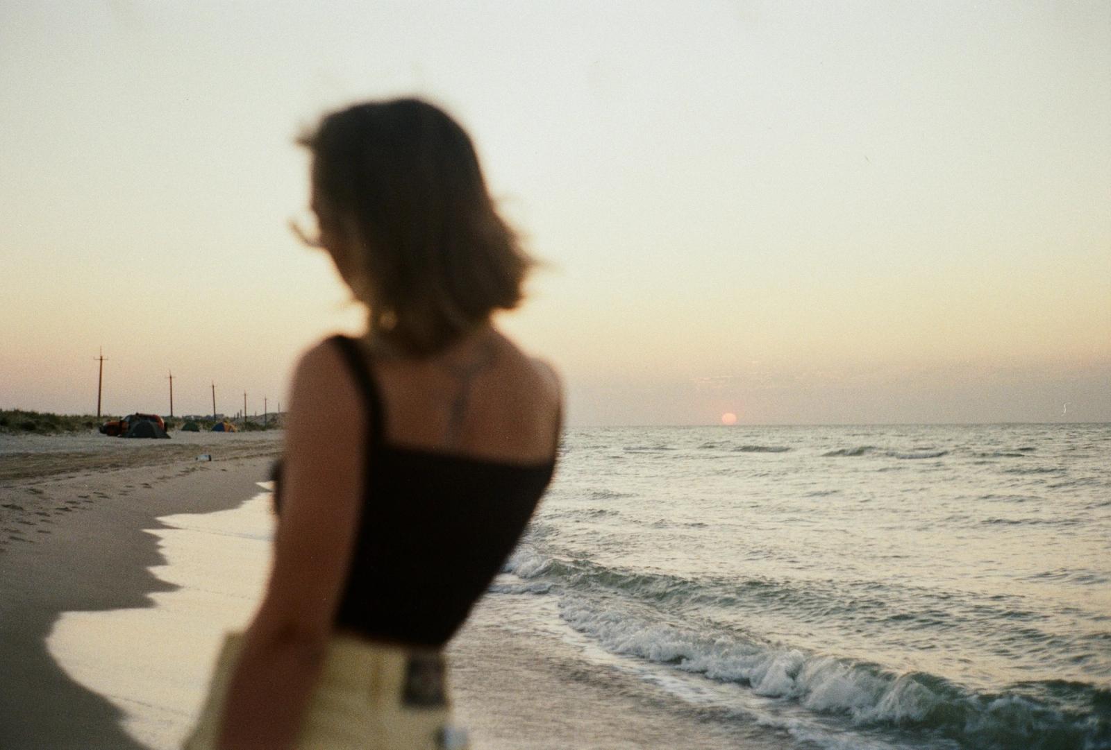 Woman's back looking at ocean