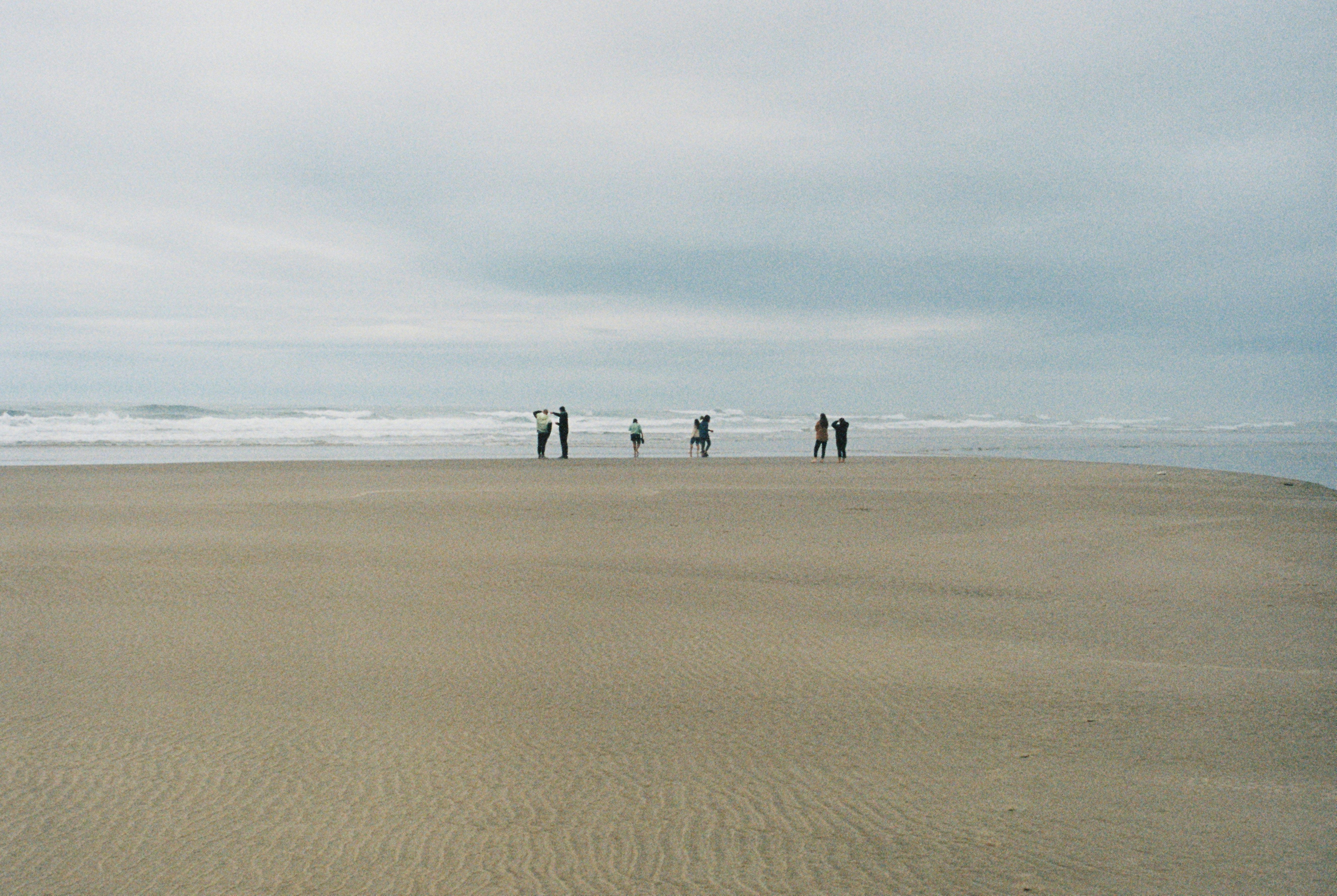 People on beach, cloudy day