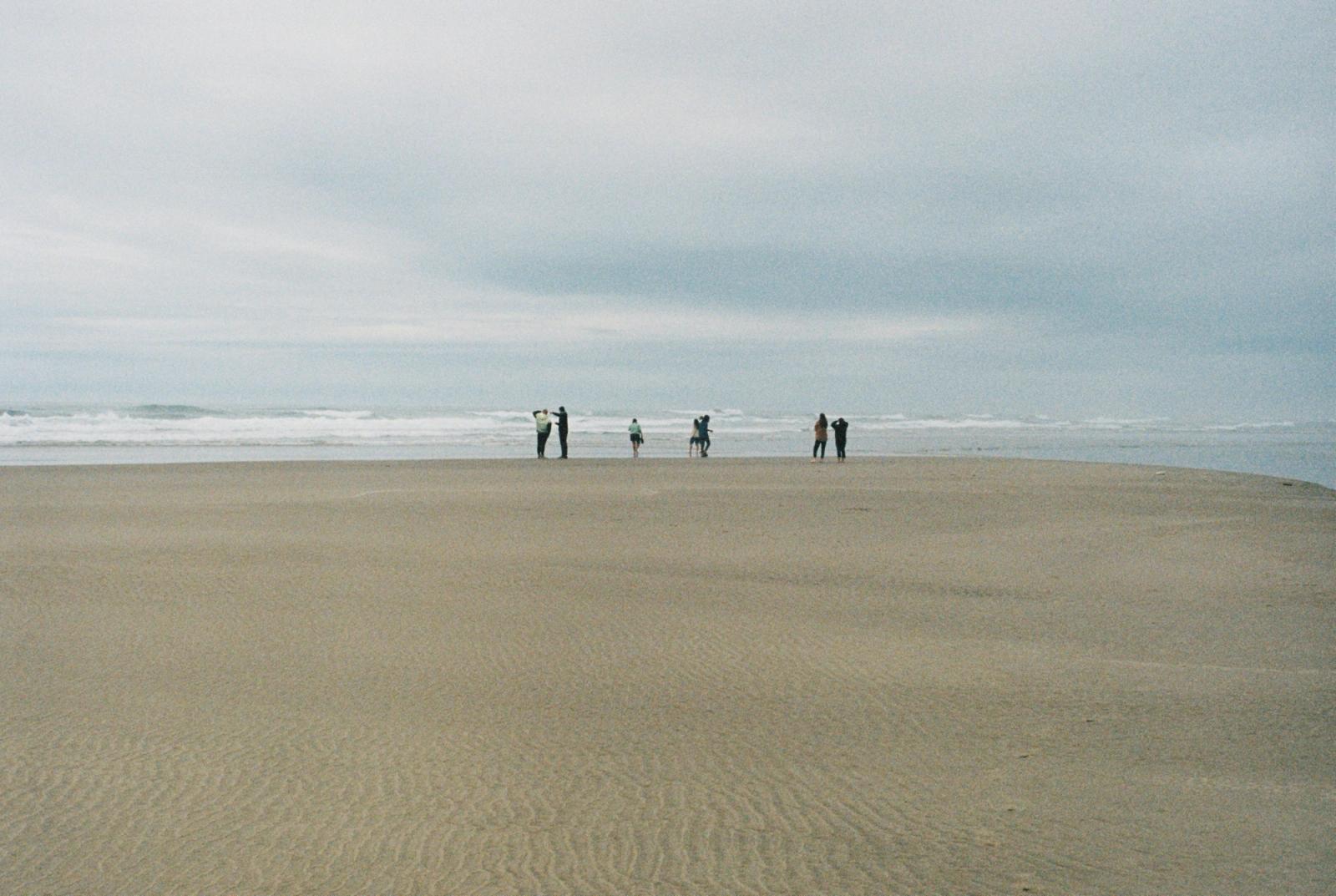 People on beach, cloudy day