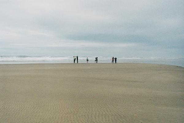 People on beach, cloudy day