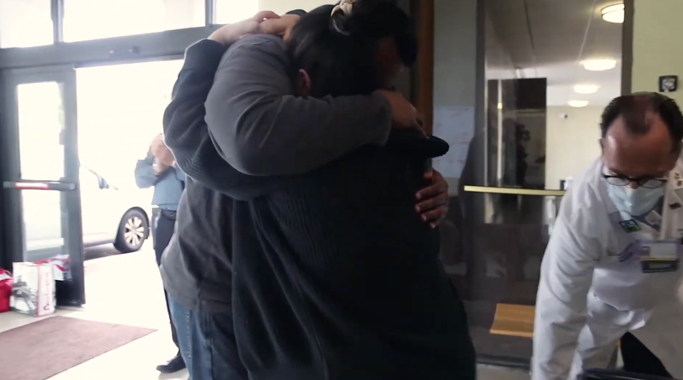 2 people embracing in a hospital