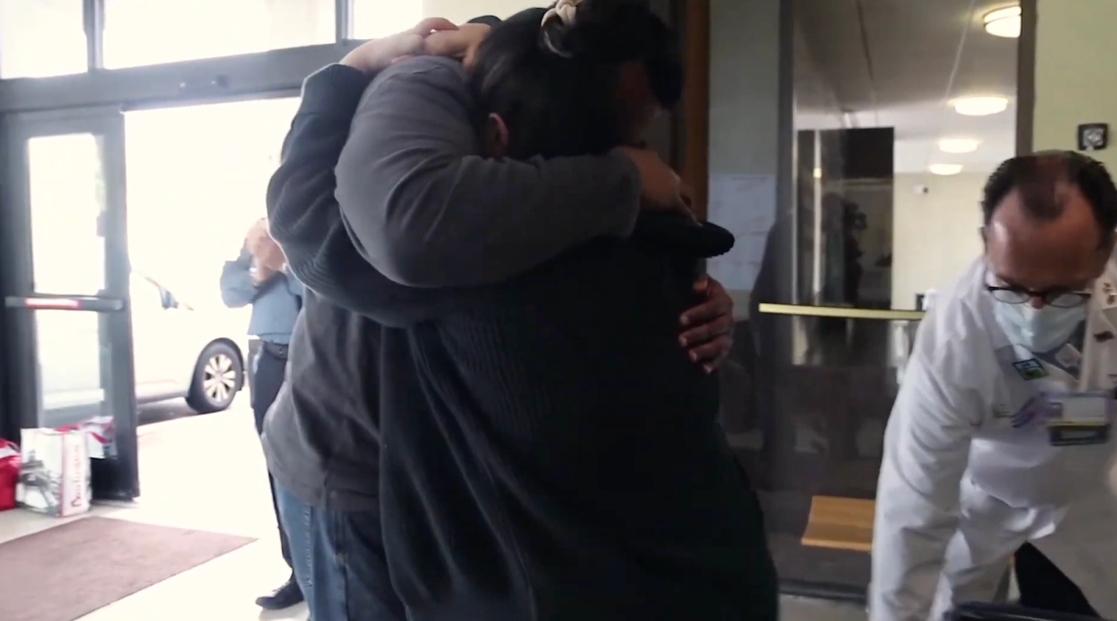 2 people embracing in a hospital