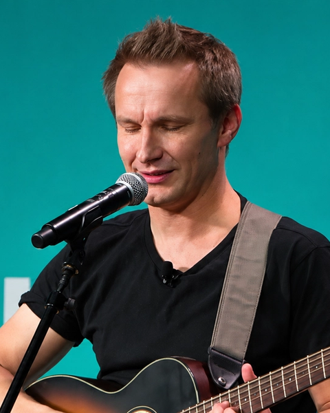 man with guitar on stage