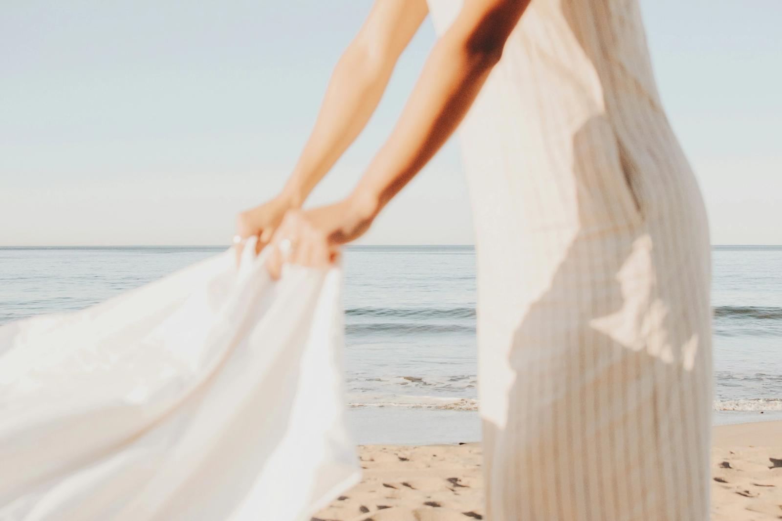 laying white blanket on beach