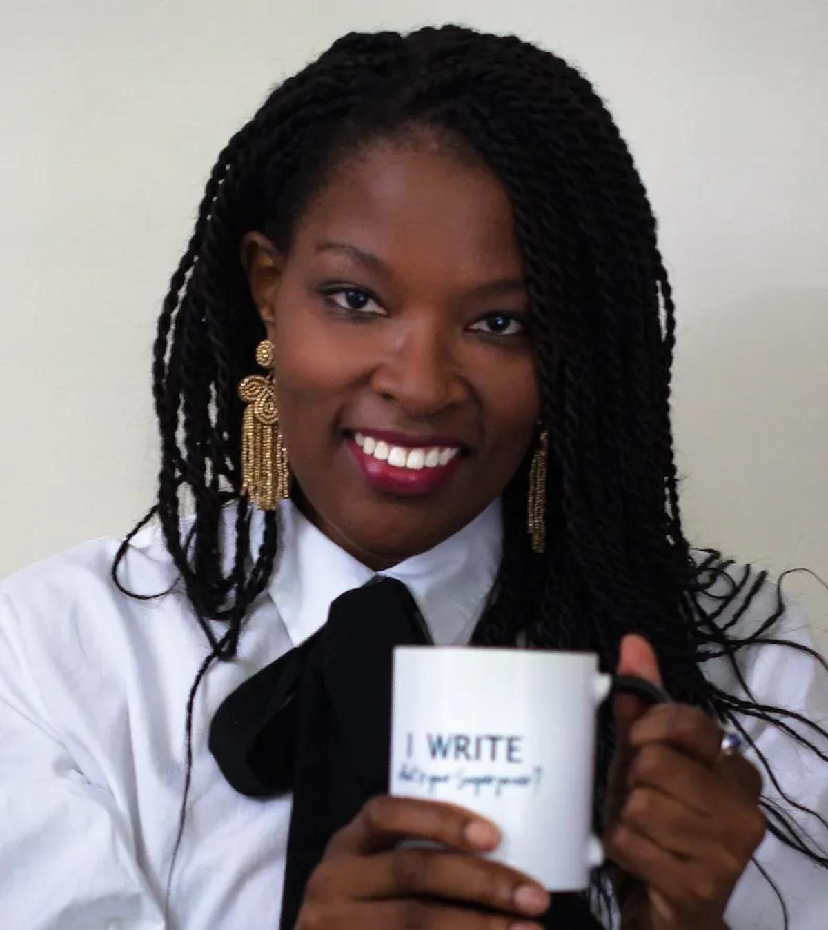 woman posing with coffee cup that says write