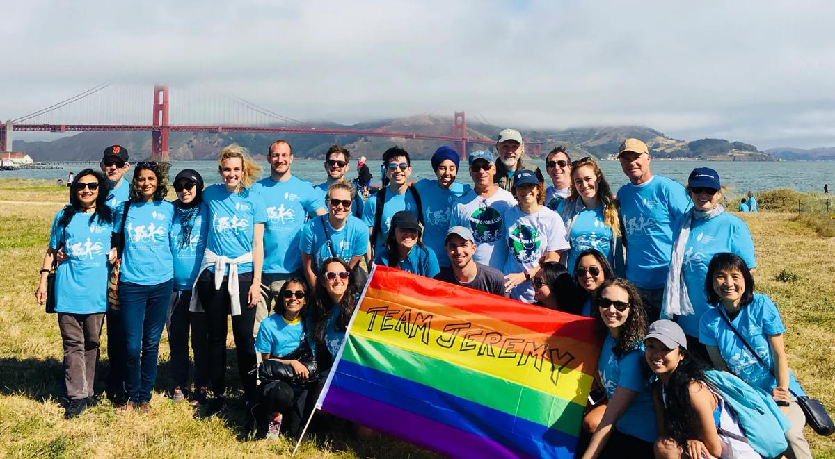 Group posing with rainbow flag