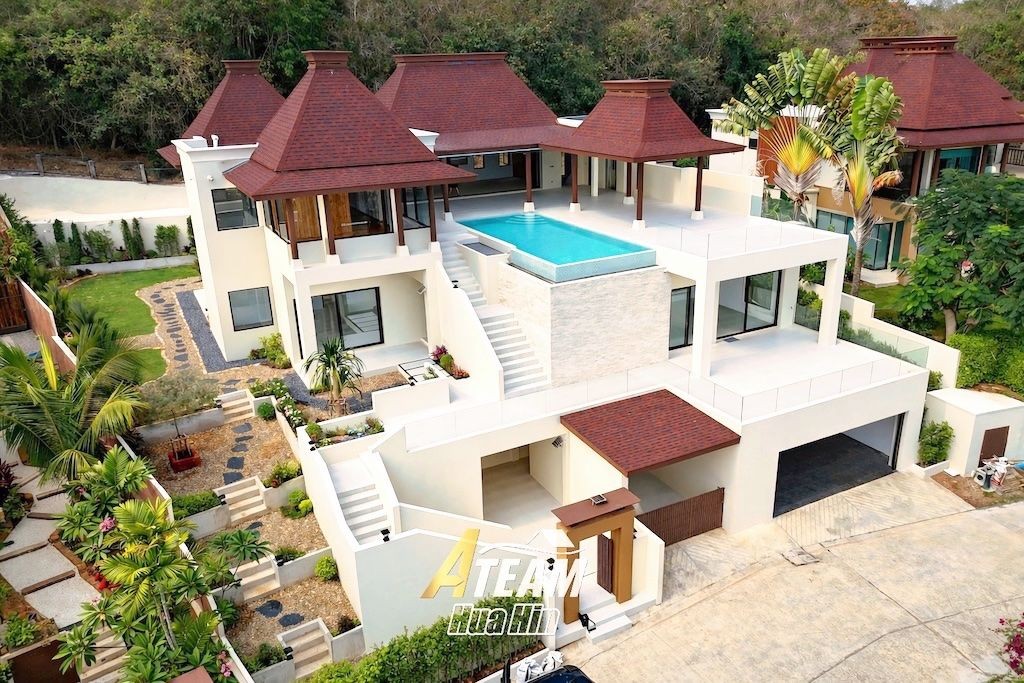 A-Team Hua Hin property consultation with buyers reviewing a home on screen