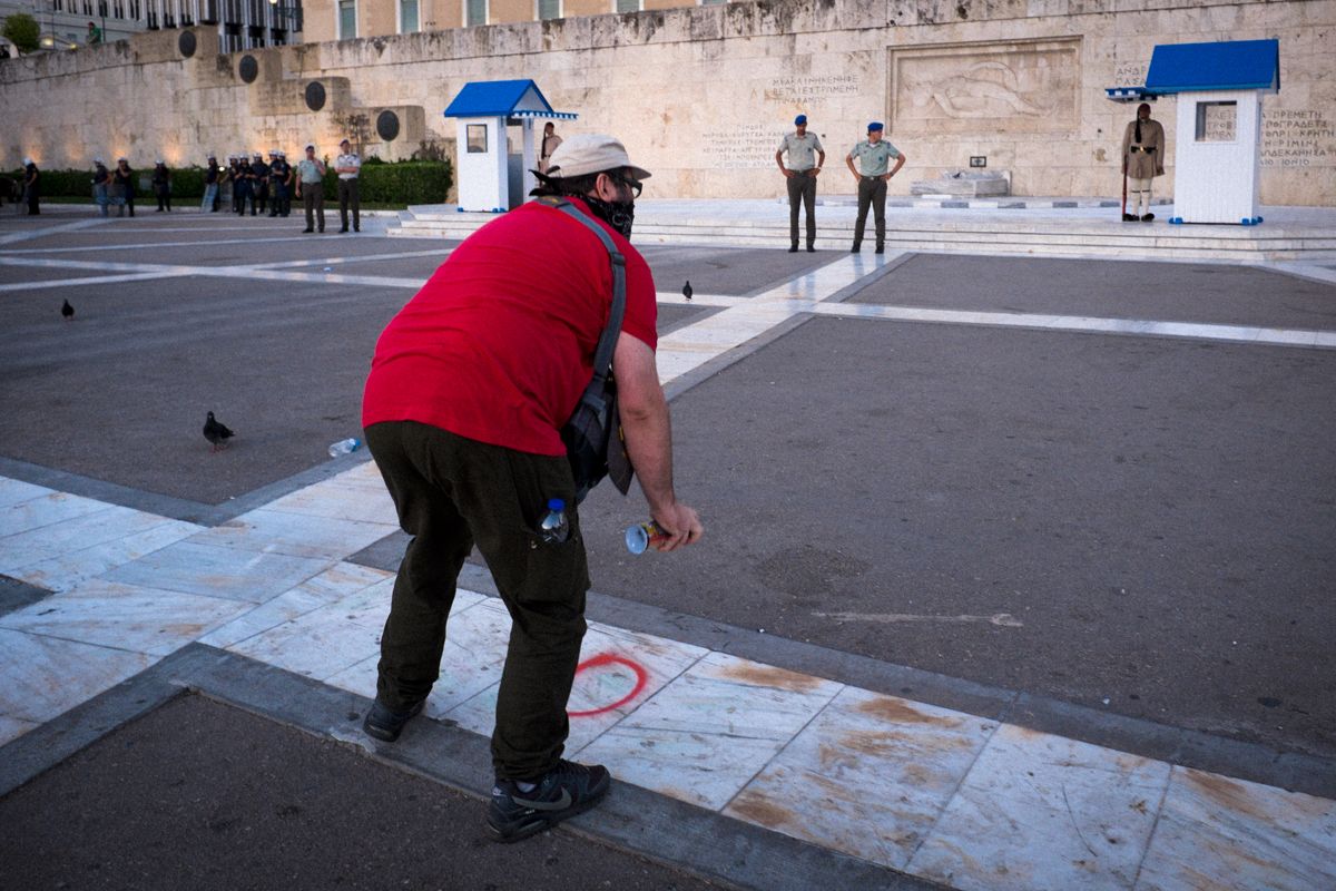 Demonstrant sprüht Graffiti mit Oxi vor das griechische Parlament während der Krise 2015